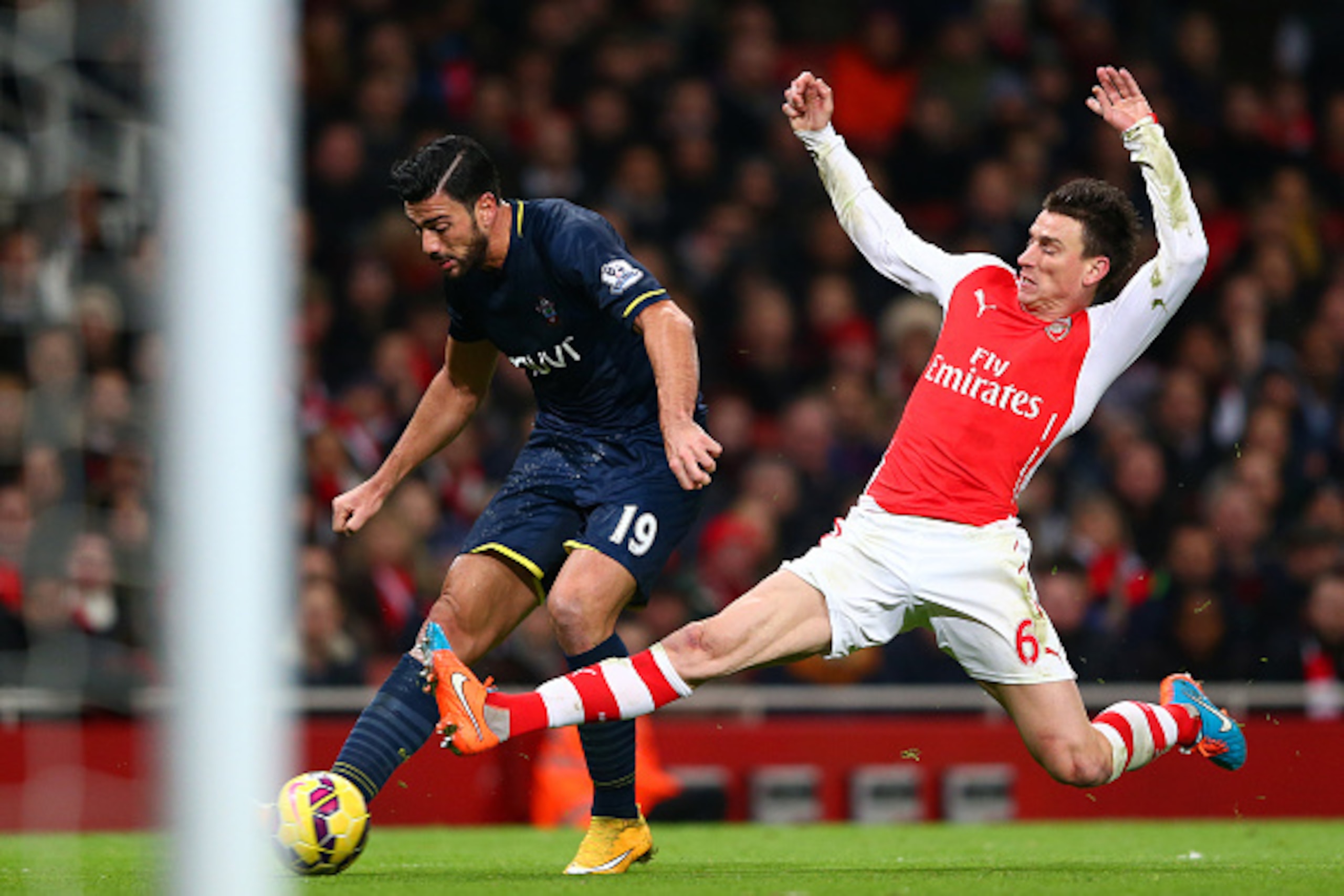 LONDON, ENGLAND - DECEMBER 03:  Laurent Koscielny of Arsenal attempts to block Graziano Pelle of Southampton during the Barclays Premier League match between Arsenal and Southampton at Emirates Stadium on December 3, 2014 in London, England.  (Photo by Mi
