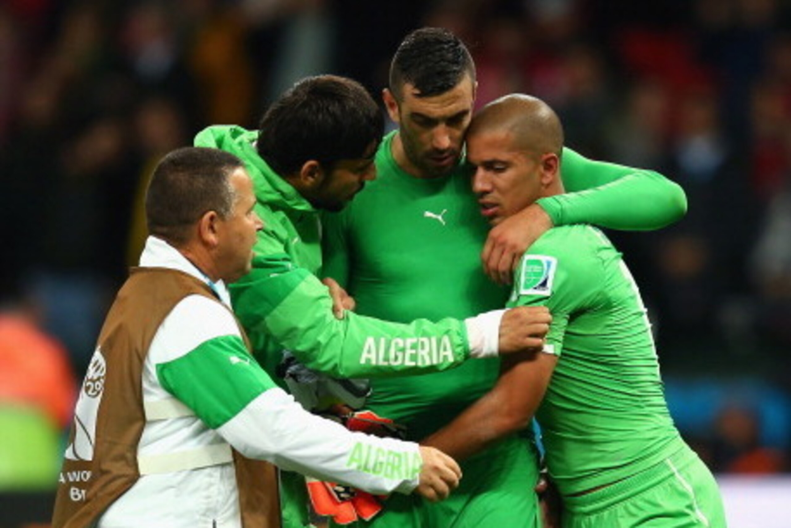 PORTO ALEGRE, BRAZIL - JUNE 30: Essaid Belkalem (2nd R) and Sofiane Feghouli of Algeria (R) react after being defeated by Germany 2-1 during the 2014 FIFA World Cup Brazil Round of 16 match between Germany and Algeria at Estadio Beira-Rio on June 30, 2014