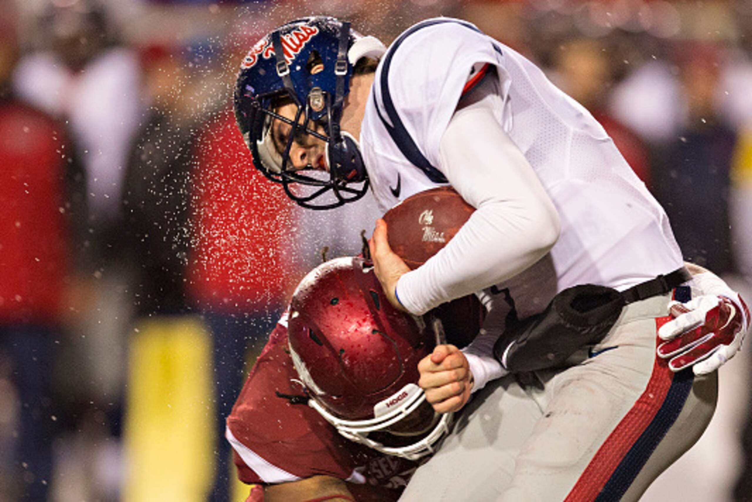 FAYETTEVILLE, AR - NOVEMBER 22:  Ryan Buchanan #9 of the Ole Miss Rebels is tackled in the fourth quarter by Darius Philon #91 of the Arkansas Razorbacks at Razorback Stadium on November 22, 2014 in Fayetteville, Arkansas.  The Razorbacks defeated the Reb