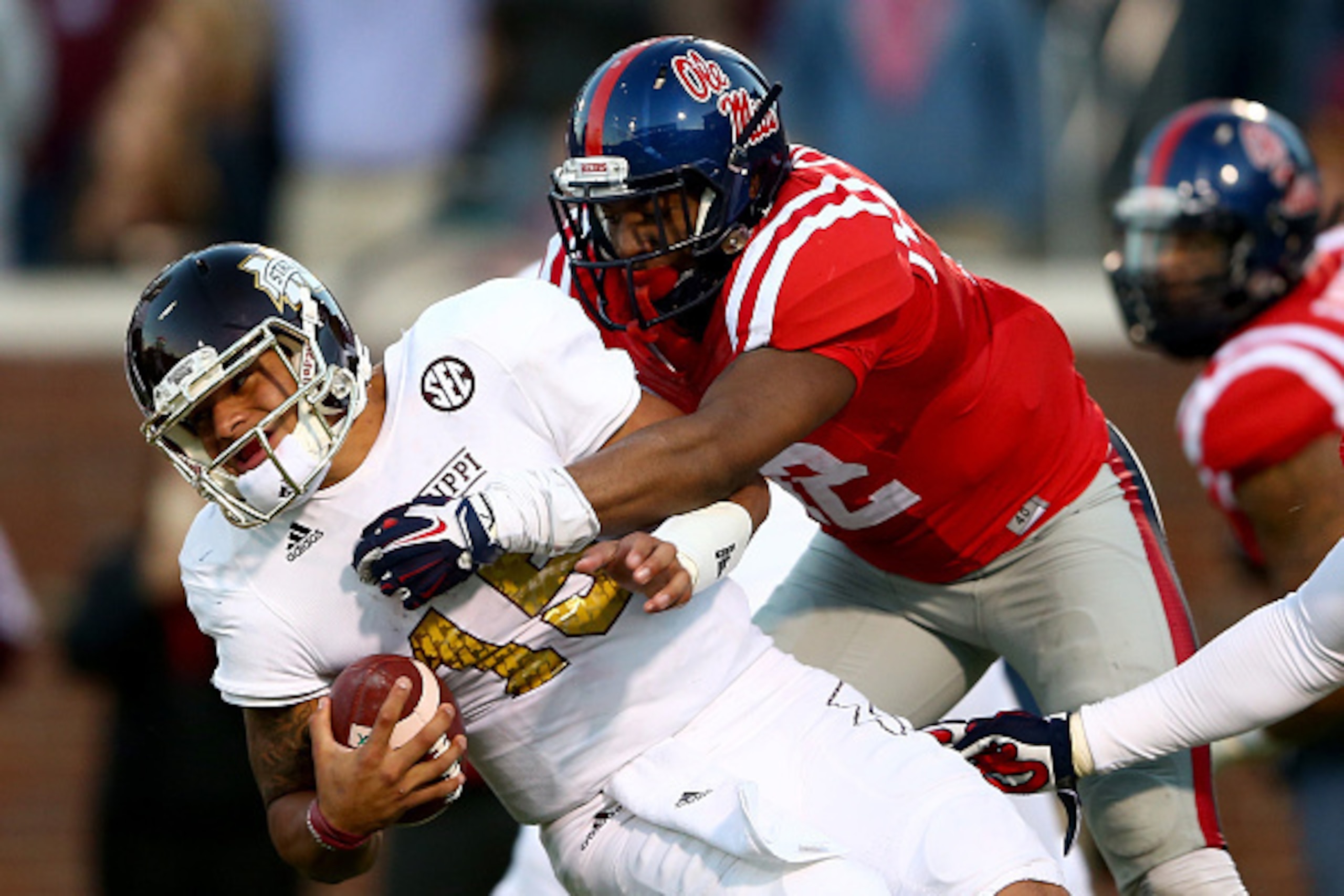 OXFORD, MS - NOVEMBER 29:  Tony Conner #12 of the Mississippi Rebels tackles Dak Prescott #15 of the Mississippi State Bulldogs during their game at Vaught-Hemingway Stadium on November 29, 2014 in Oxford, Mississippi.  (Photo by Streeter Lecka/Getty Imag