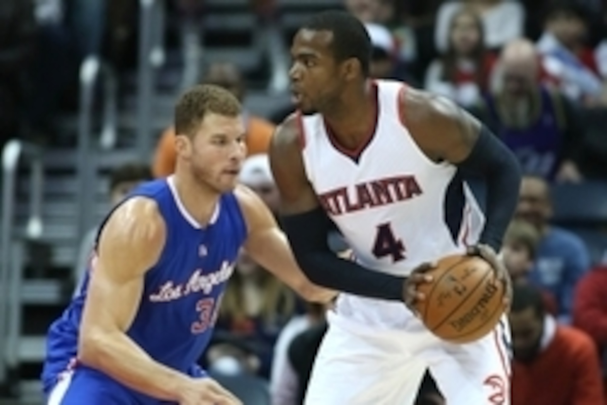 Dec 23, 2014; Atlanta, GA, USA; Atlanta Hawks forward Paul Millsap (4) goes against Los Angeles Clippers forward Blake Griffin (32) in the first quarter of their game at Philips Arena. Mandatory Credit: Jason Getz-USA TODAY Sports