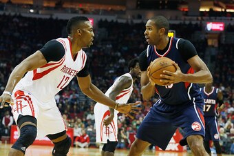 HOUSTON, TX - DECEMBER 20:  Dwight Howard #12 of the Houston Rockets defends against Al Horford #15 of the Atlanta Hawks during their game at the Toyota Center on December 20, 2014 in Houston, Texas.  (Photo by Scott Halleran/Getty Images)