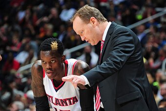 ATLANTA, GA - DECEMBER 30: Head Coach Mike Budenholzer of the Atlanta Hawks discusses a play with Dennis Schroder #17 during the game against the Cleveland Cavaliers on December 30, 2014 at Philips Arena in Atlanta, Georgia.  NOTE TO USER: User expressly 