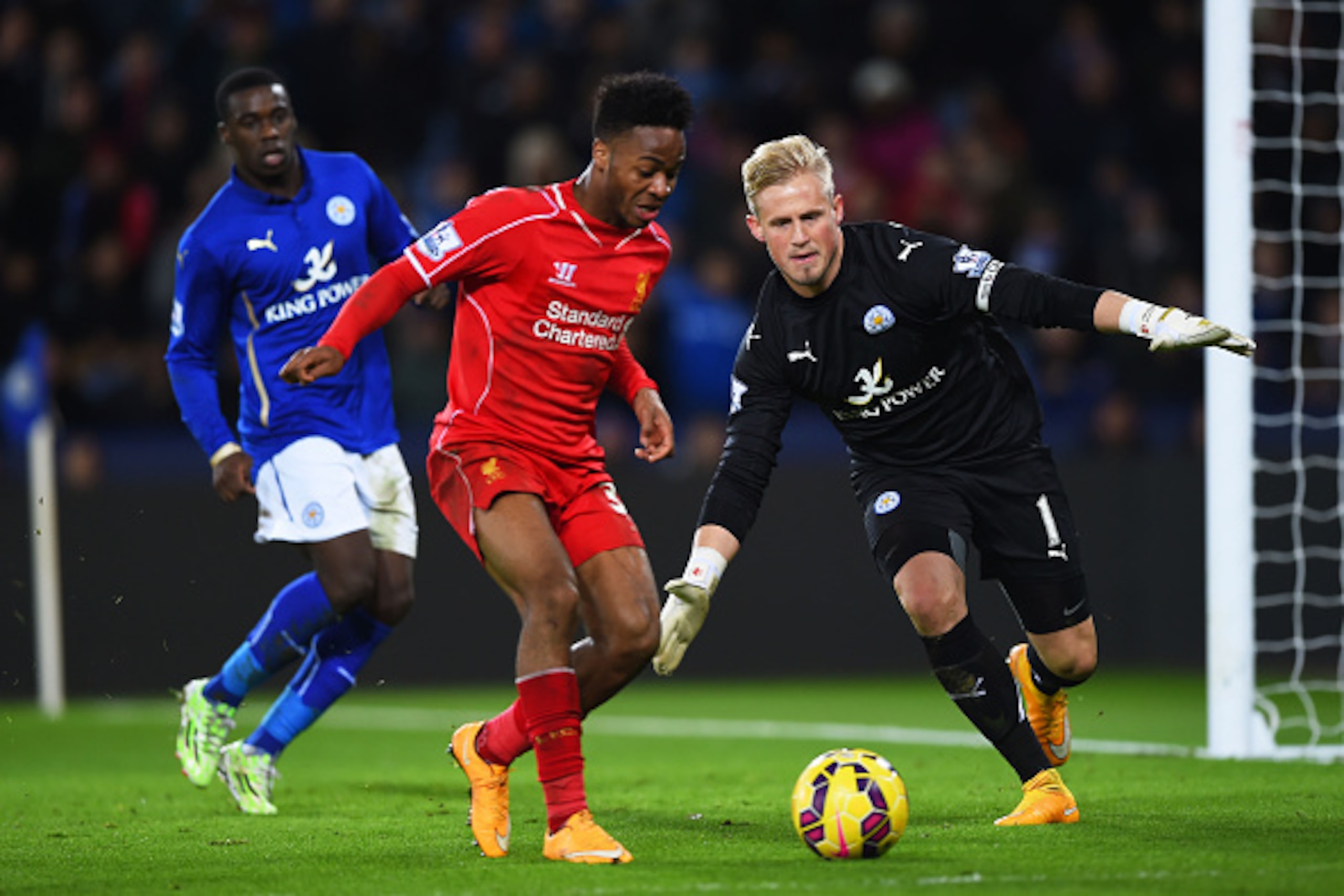 LEICESTER, ENGLAND - DECEMBER 02:  Kasper Schmeichel of Leicester City closes down Raheem Sterling of Liverpool during the Barclays Premier League match between Leicester City and Liverpool at The King Power Stadium on December 2, 2014 in Leicester, Engla
