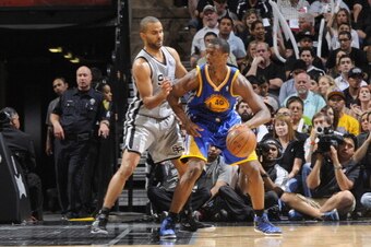SAN ANTONIO, TX - MAY 14:  Harrison Barnes #40 of the Golden State Warriors protects the ball from Tony Parker #9 of the San Antonio Spurs during the Game Five of the Western Conference Semifinals between the Golden State Warriors and the San Antonio Spur