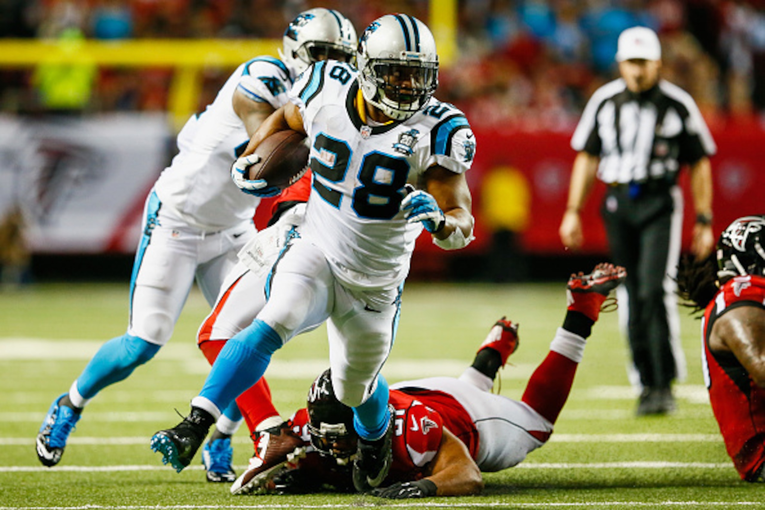 ATLANTA, GA - DECEMBER 28: Jonathan Stewart #28 of the Carolina Panthers breaks away from Corey Peters #91 of the Atlanta Falcons on a run in the first half at the Georgia Dome on December 28, 2014 in Atlanta, Georgia.  (Photo by Kevin C. Cox/Getty Images