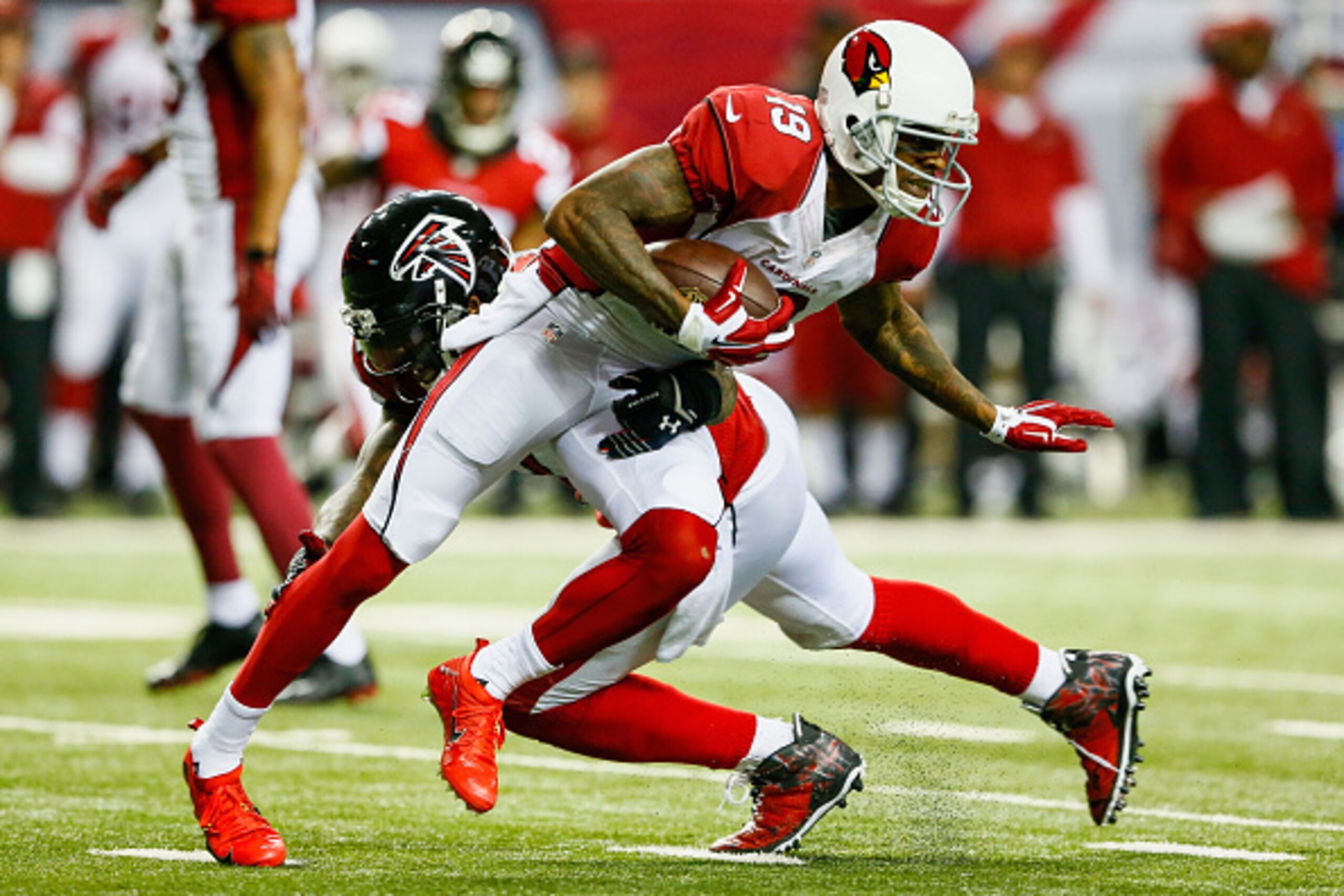 ATLANTA, GA - NOVEMBER 30: Ted Ginn Jr. #19 of the Arizona Cardinals breaks a tackle by William Moore #25 of the Atlanta Falcons after a catch during the second half at the Georgia Dome on November 30, 2014 in Atlanta, Georgia.  (Photo by Kevin C. Cox/Get