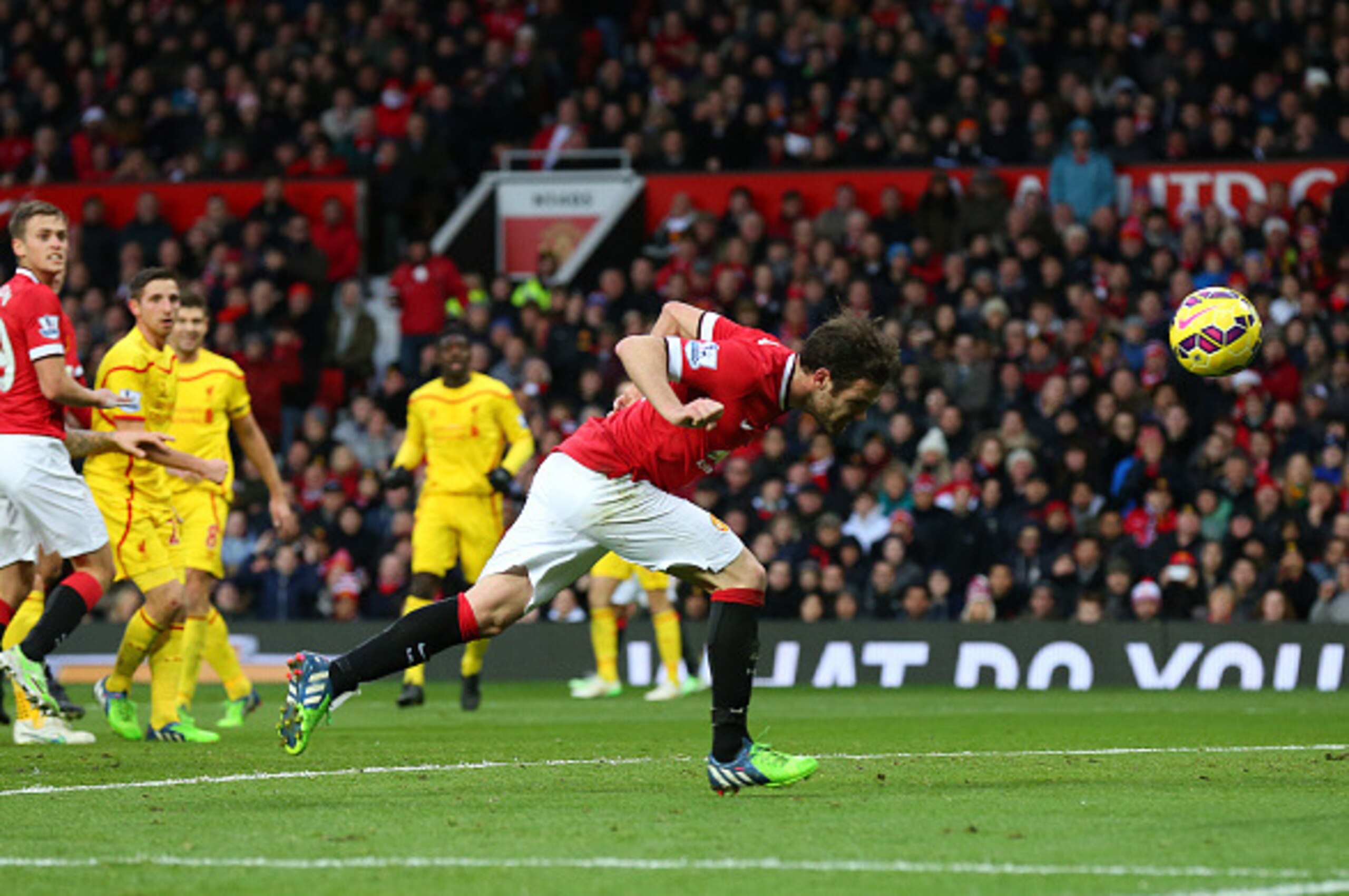 MANCHESTER, ENGLAND - DECEMBER 14:  Juan Mata of Manchester United scores the second goal during the Barclays Premier League match between Manchester United and Liverpool at Old Trafford on December 14, 2014 in Manchester, England.  (Photo by Alex Livesey
