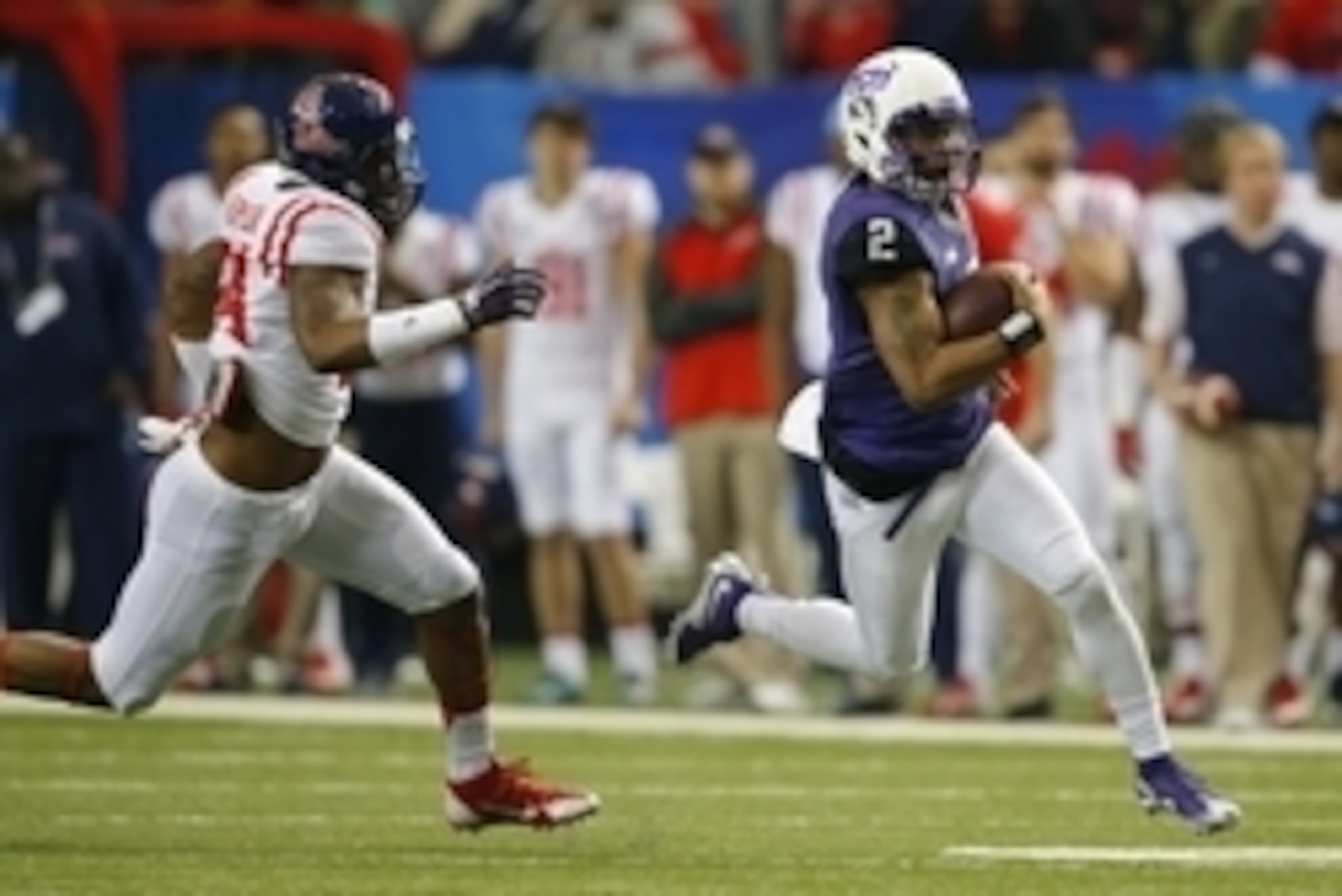 Dec 31, 2014; Atlanta , GA, USA; TCU Horned Frogs quarterback Trevone Boykin (2) runs past Mississippi Rebels defensive end Carlos Thompson (54) during the first quarter in the 2014 Peach Bowl at the Georgia Dome. Mandatory Credit: Paul Abell/CFA Peach Bo