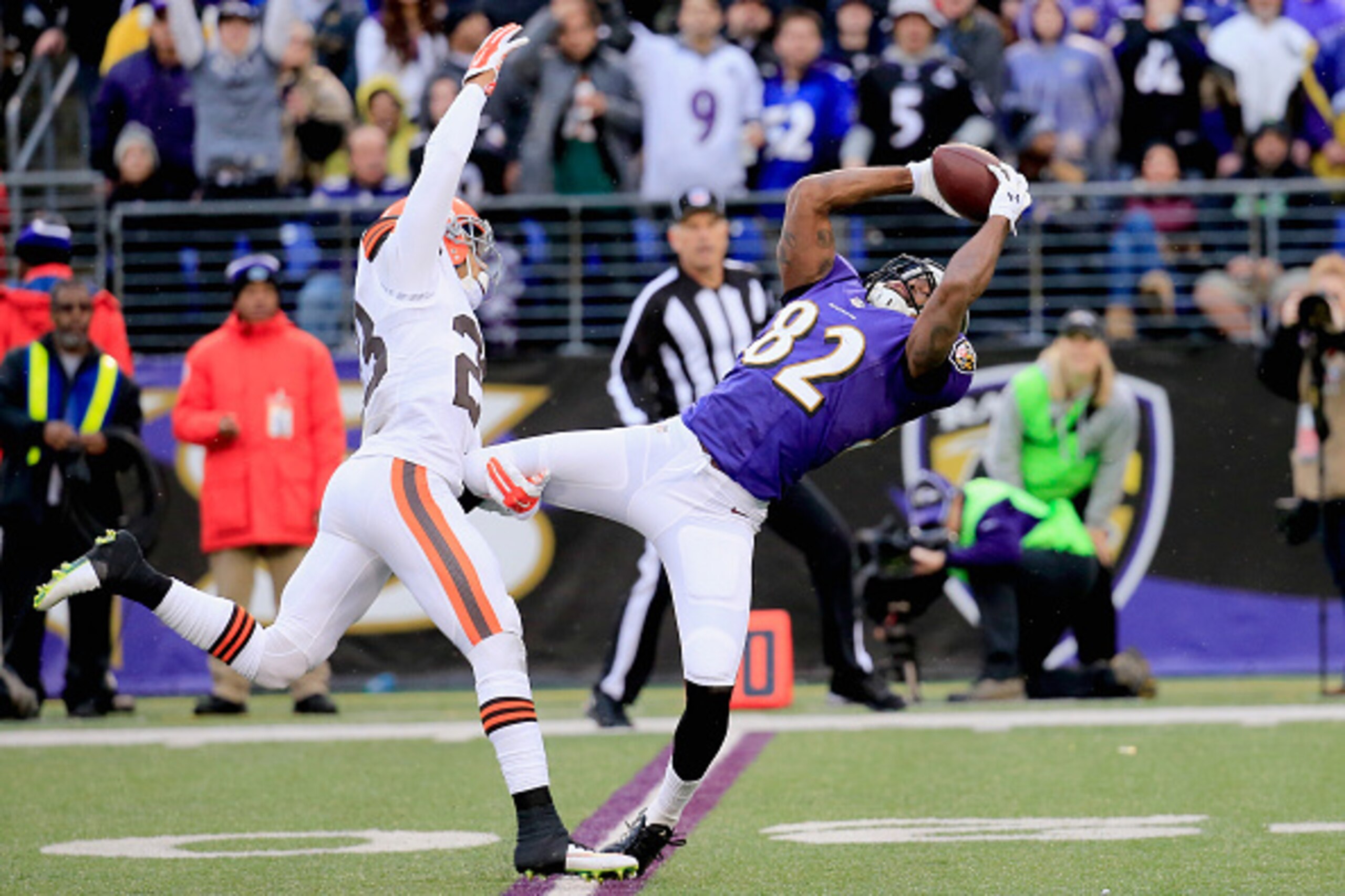 BALTIMORE, MD - DECEMBER 28:  Wide receiver Torrey Smith #82 of the Baltimore Ravens makes a fourth quarter catch past the defense of cornerback Joe Haden #23 of the Cleveland Browns at M&T Bank Stadium on December 28, 2014 in Baltimore, Maryland.  (Photo