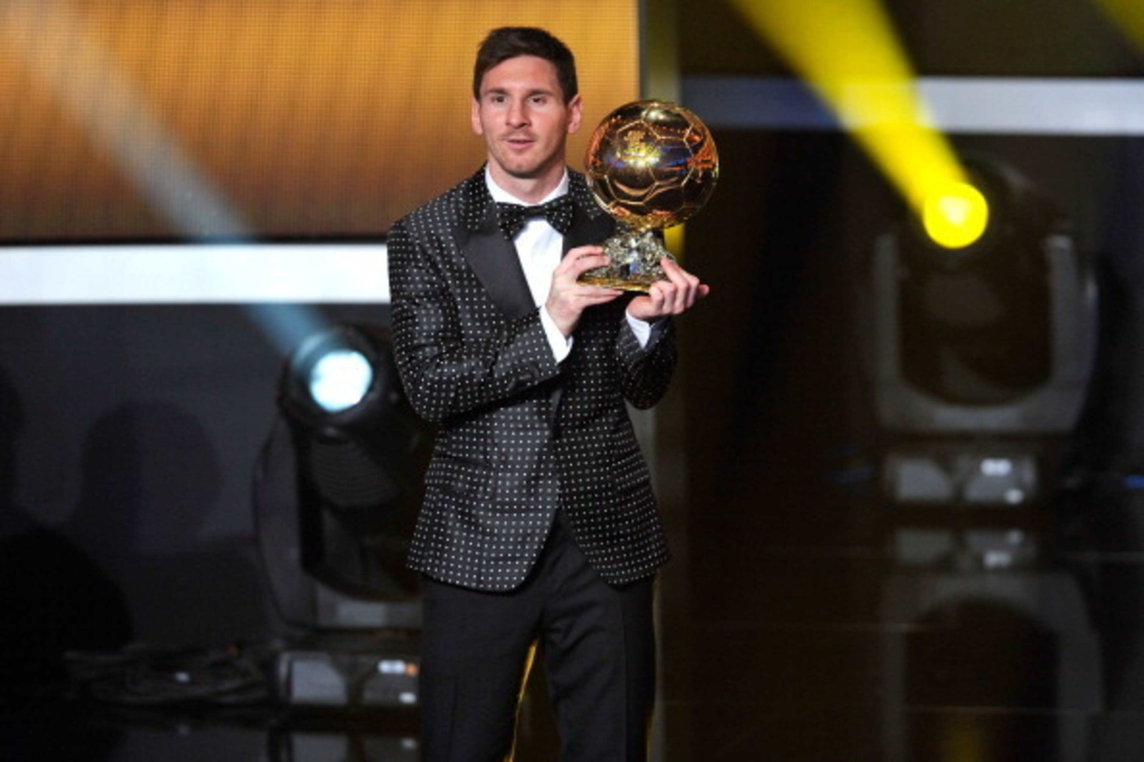 ZURICH, SWITZERLAND - JANUARY 07:  Lionel Messi of Argentina holds the trophy after winning the FIFA Ballon d'Or for a fourth consecutive time during the FIFA Ballon d'Or Gala 2013 at Congress House on January 7, 2013 in Zurich, Switzerland.  (Photo by Ha