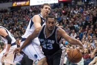 Dec 20, 2014; Dallas, TX, USA; San Antonio Spurs forward Boris Diaw (33) tries to keep the ball in bounds in front of Dallas Mavericks forward Dirk Nowitzki (41) during the first half at the American Airlines Center. Mandatory Credit: Jerome Miron-USA TOD