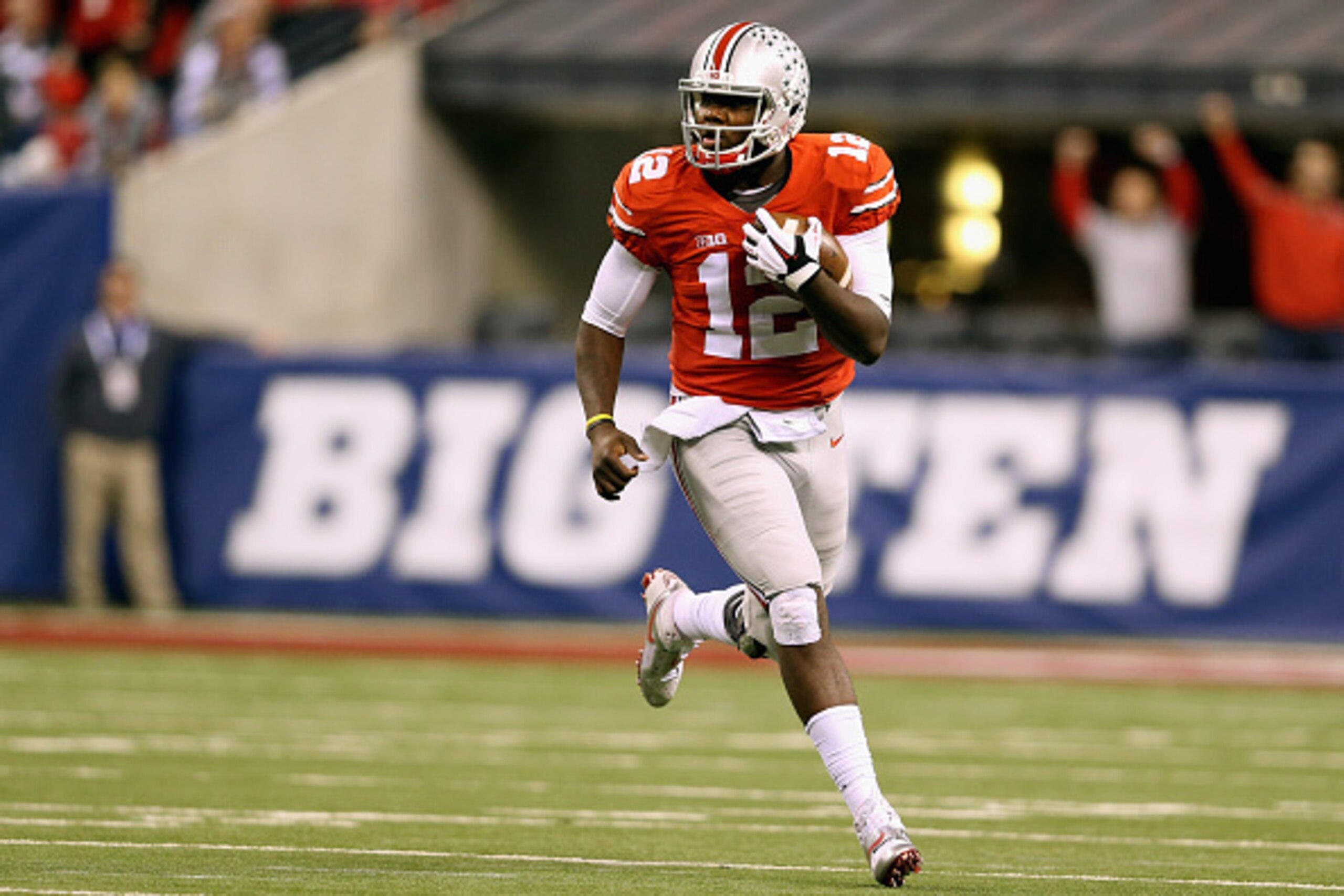 INDIANAPOLIS, IN - DECEMBER 06: Quarterback Cardale Jones #12 of the Ohio State Buckeyes runs with the ball during the third quarter against the Wisconsin Badgers in the Big Ten Championship at Lucas Oil Stadium on December 6, 2014 in Indianapolis, India INDIANAPOLIS, IN - DECEMBER 06: Quarterback Cardale Jones #12 of the Ohio State Buckeyes runs with the ball during the third quarter against the Wisconsin Badgers in the Big Ten Championship at Lucas Oil Stadium on December 6, 2014 in Indianapolis, India