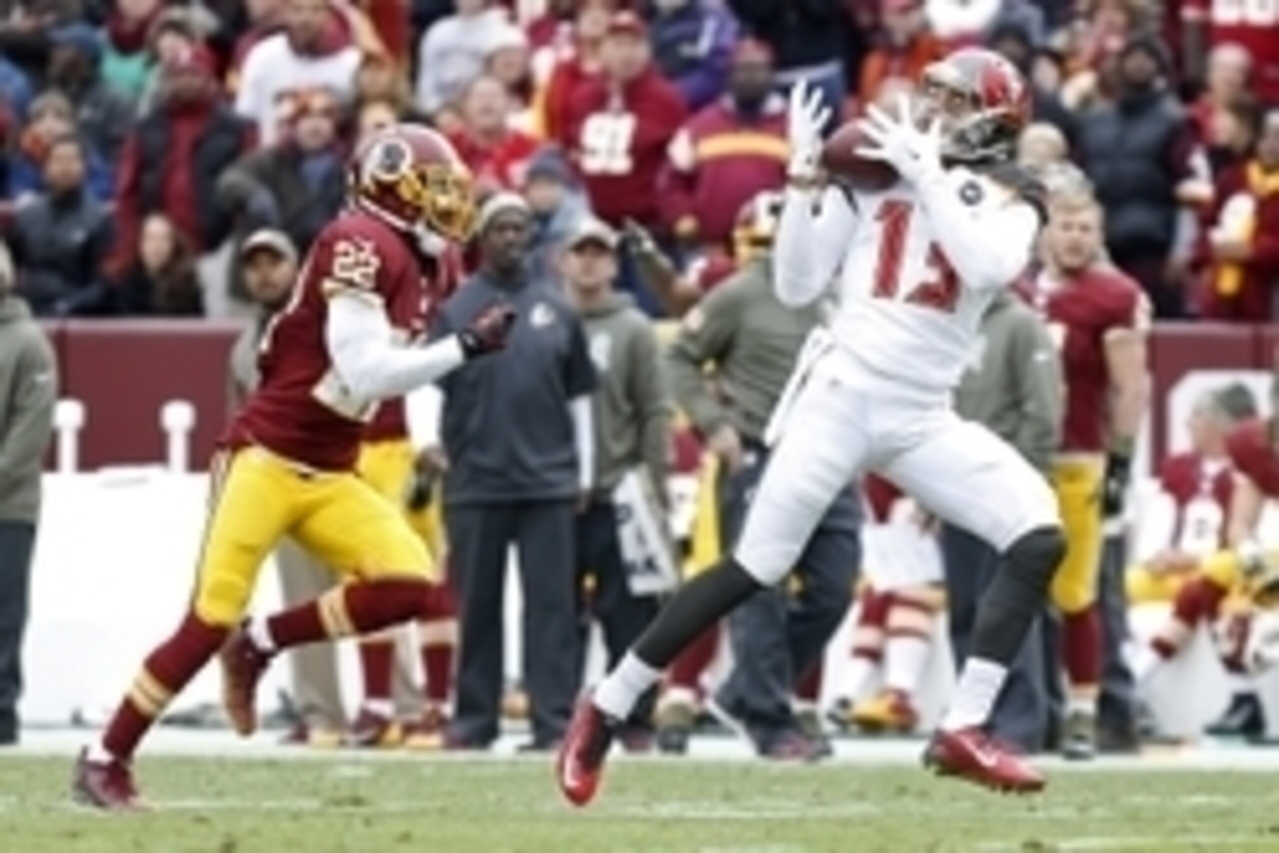 Nov 16, 2014; Landover, MD, USA; Tampa Bay Buccaneers wide receiver Mike Evans (13) catches the ball as Washington Redskins cornerback Tracy Porter (22) defends in the second quarter at FedEx Field. Mandatory Credit: Geoff Burke-USA TODAY Sports