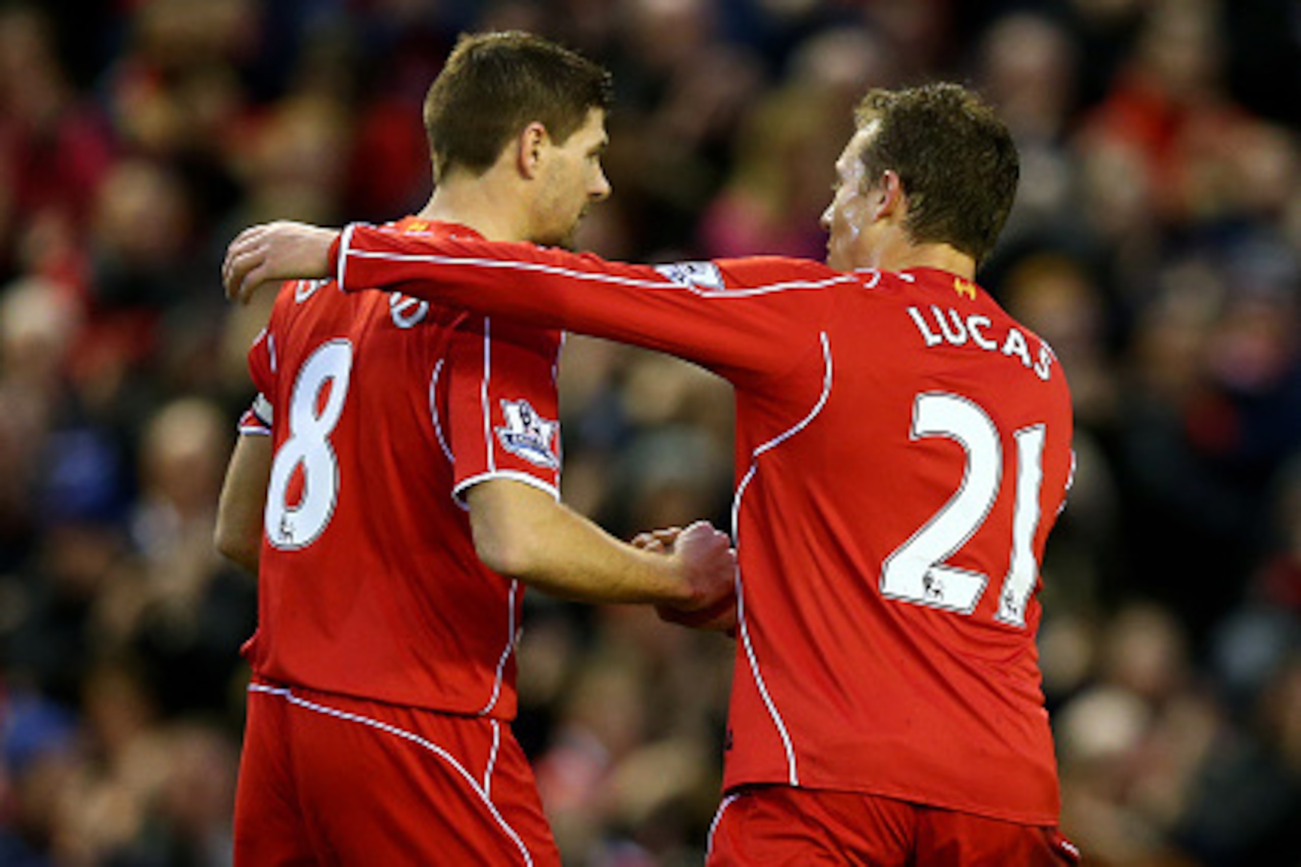LIVERPOOL, ENGLAND - JANUARY 01:  Steven Gerrard of Liverpool is congratulated by teammate Lucas Leiva of Liverpool after scoring the opening goal from the penalty spot during the Barclays Premier League match between Liverpool and Leicester City at Anfie