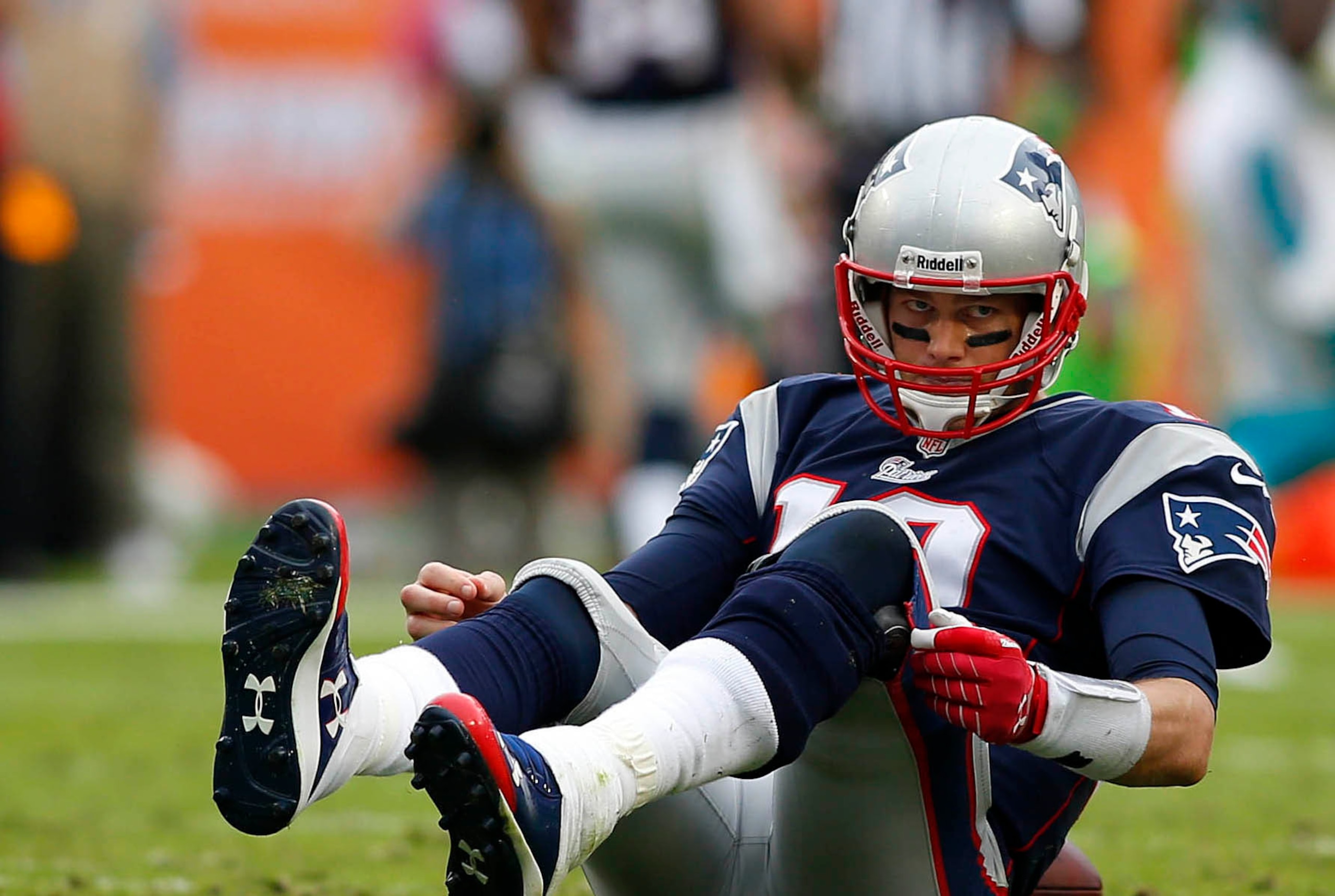Dec 15, 2013; Miami Gardens, FL, USA:  New England Patriots quarterback Tom Brady (12) on the ground after a sack by Miami Dolphins defensive end Cameron Wake (not pictured) in the second half at Sun Life Stadium. The Dolphins won 24-20. Mandatory Credit: