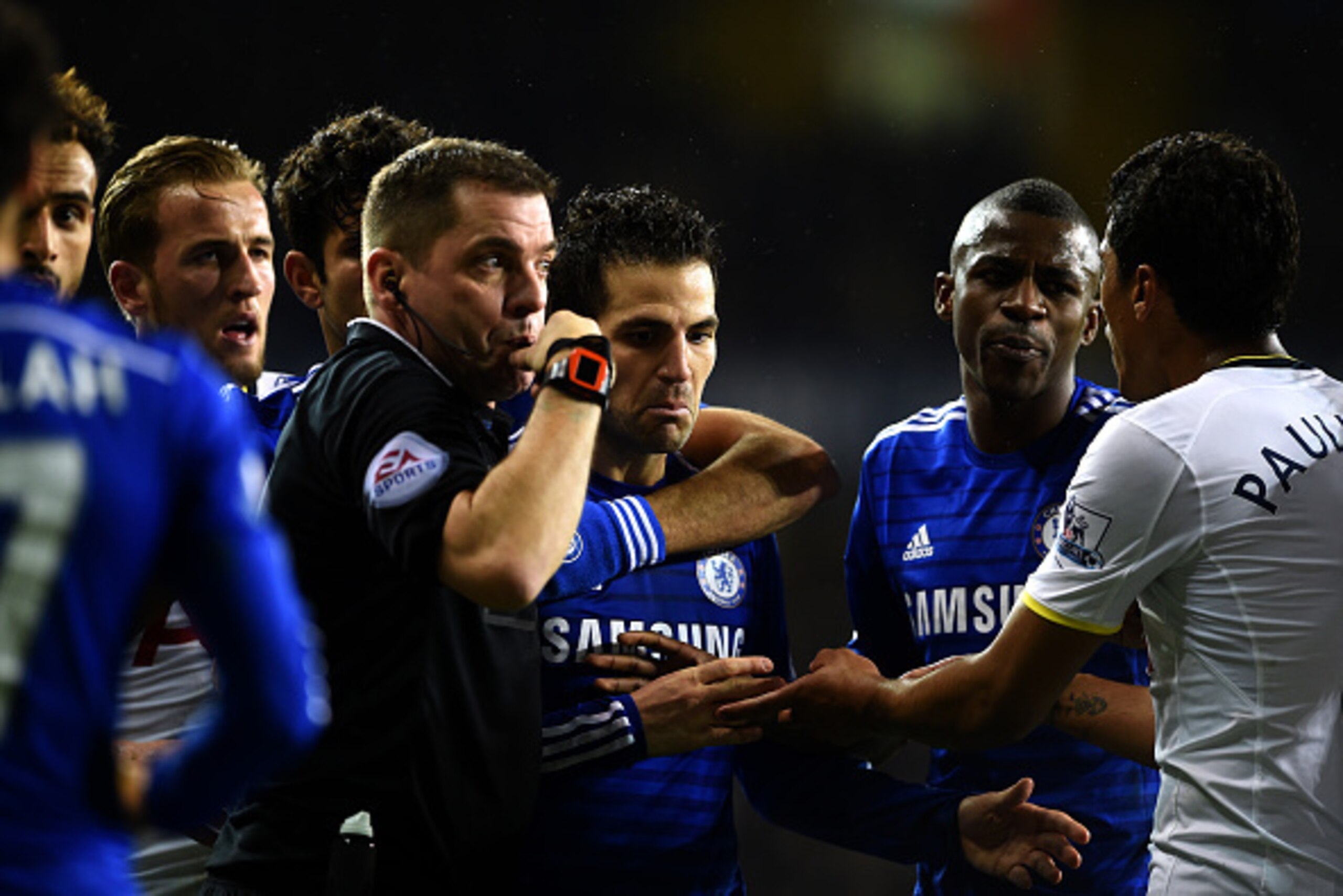LONDON, ENGLAND - JANUARY 01:  Referee Phil Dowd is surrounded by players during the Barclays Premier League match between Tottenham Hotspur and Chelsea at White Hart Lane on January 1, 2015 in London, England.  (Photo by Michael Regan/Getty Images)