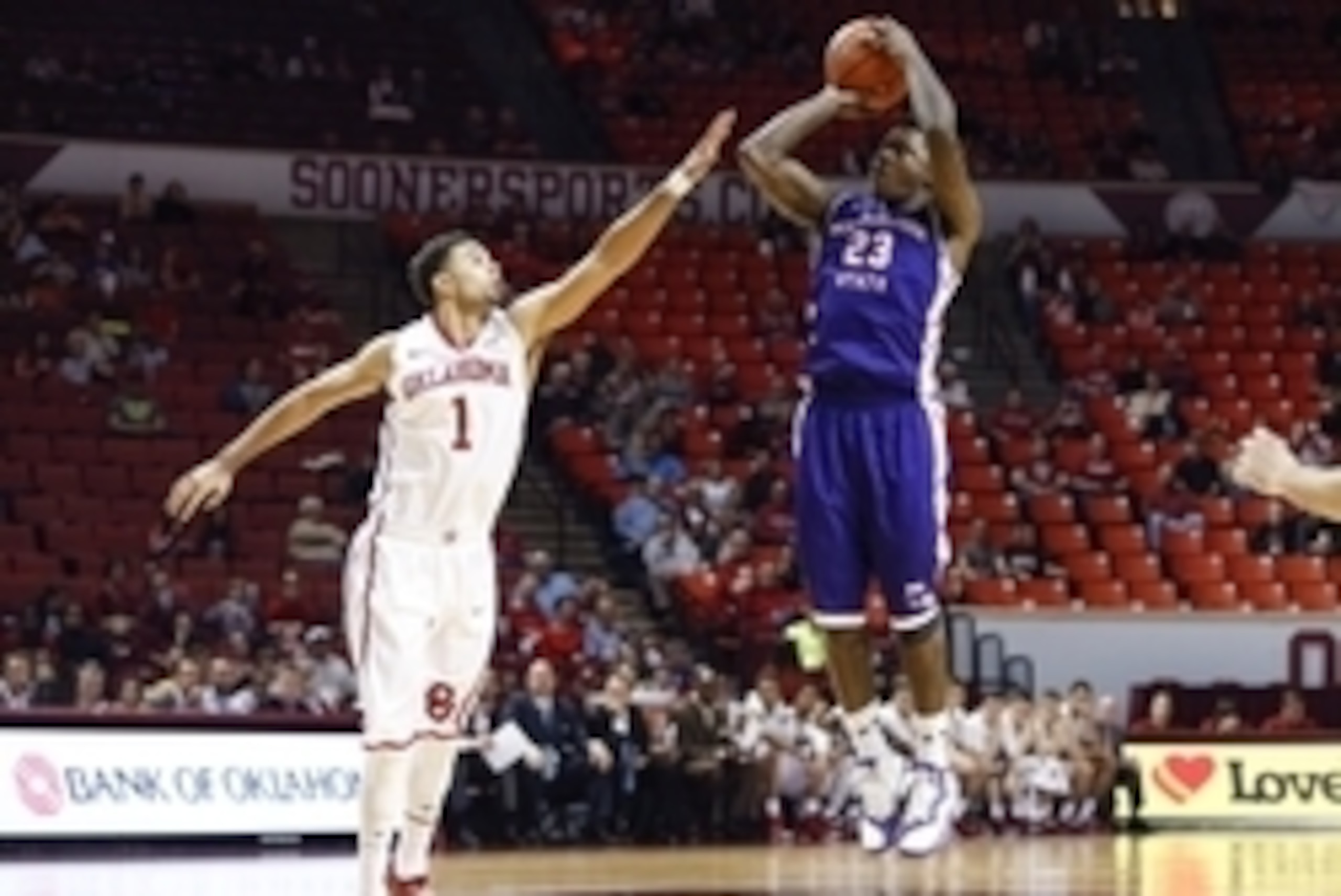 Nov 23, 2014; Norman, OK, USA; Northwestern State Demons guard Zeek Woodley (23) shoots over Oklahoma Sooners guard Frank Booker (1) during the game at Lloyd Noble Center. Oklahoma won 90-68. Mandatory Credit: Kevin Jairaj-USA TODAY Sports Nov 23, 2014; Norman, OK, USA; Northwestern State Demons guard Zeek Woodley (23) shoots over Oklahoma Sooners guard Frank Booker (1) during the game at Lloyd Noble Center. Oklahoma won 90-68. Mandatory Credit: Kevin Jairaj-USA TODAY Sports
