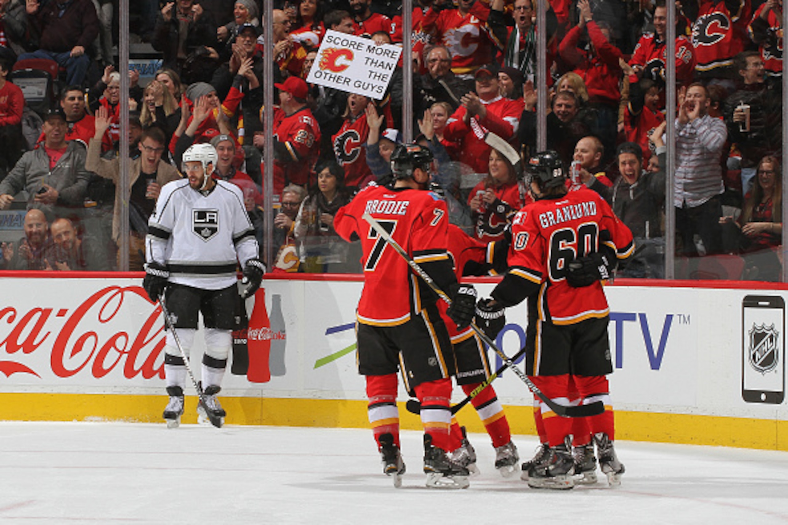 CALGARY, AB - DECEMBER 29: TJ Brodie #7 and Markus Granlund #60 of the Calgary Flames celebrate with teammates after a goal against the Los Angeles Kings at Scotiabank Saddledome on December 29, 2014 in Calgary, Alberta, Canada. (Photo by Brad Watson/NHLI