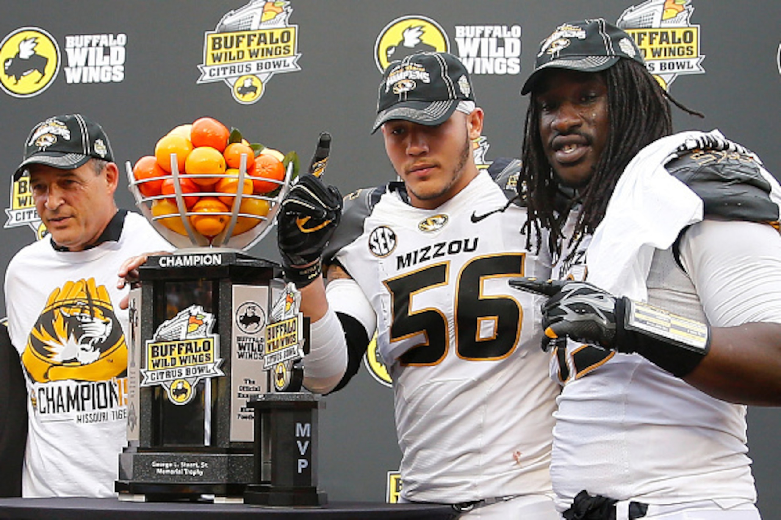 ORLANDO, FL - JANUARY 01:  Head coach Gary Pinkel of the Missouri Tigers, Shane Ray #56, and Markus Golden #33 pose with the championship trophy following the Buffalo Wild Wings Citrus Bowl at the Florida Citrus Bowl on January 1, 2015 in Orlando, Florida