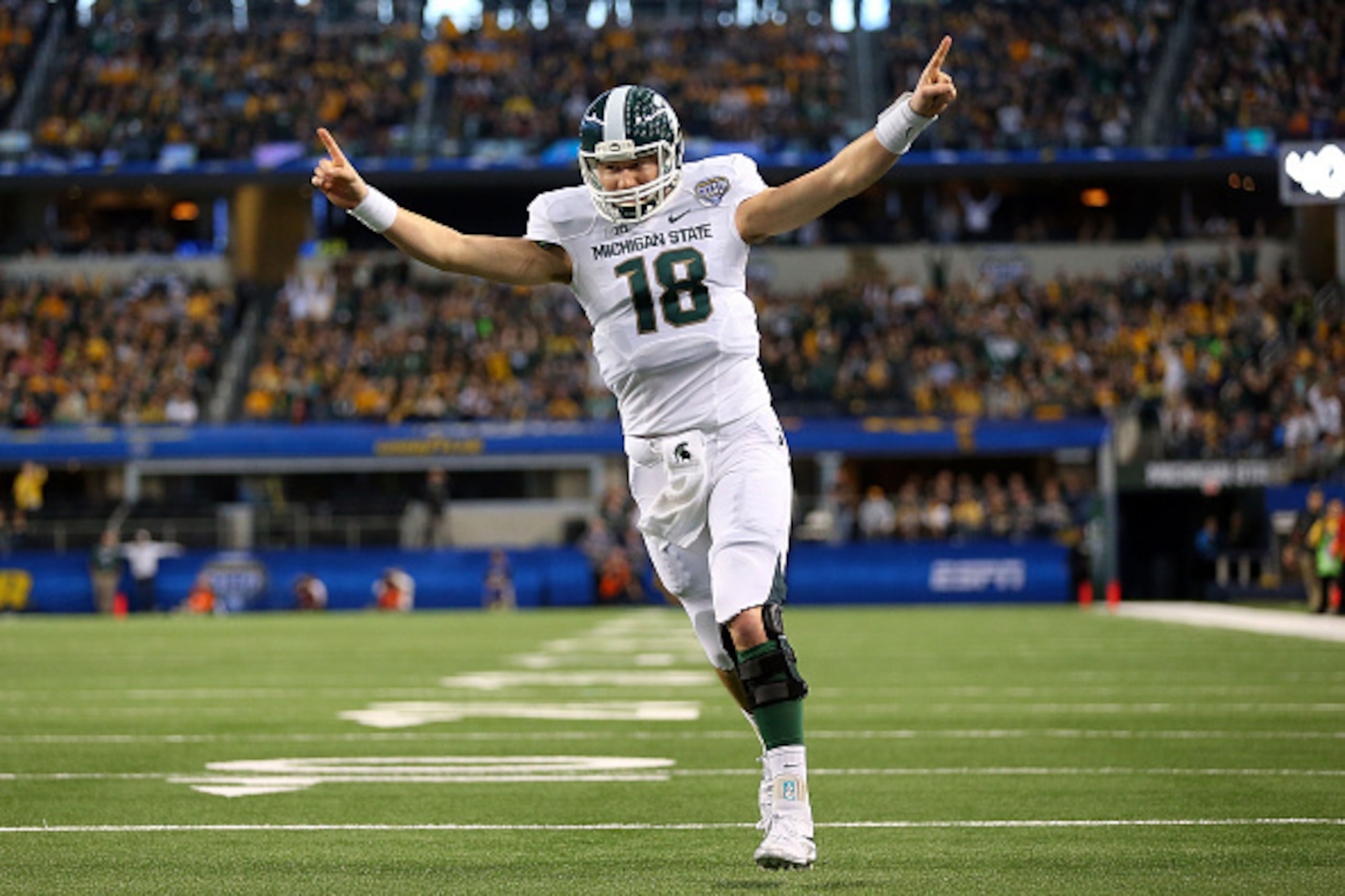 ARLINGTON, TX - JANUARY 01:  Connor Cook #18 of the Michigan State Spartans celebrates after the Spartans score a touchdown against the Baylor Bears during the first half of the Goodyear Cotton Bowl Classic at AT&T Stadium on January 1, 2015 in Arlington,