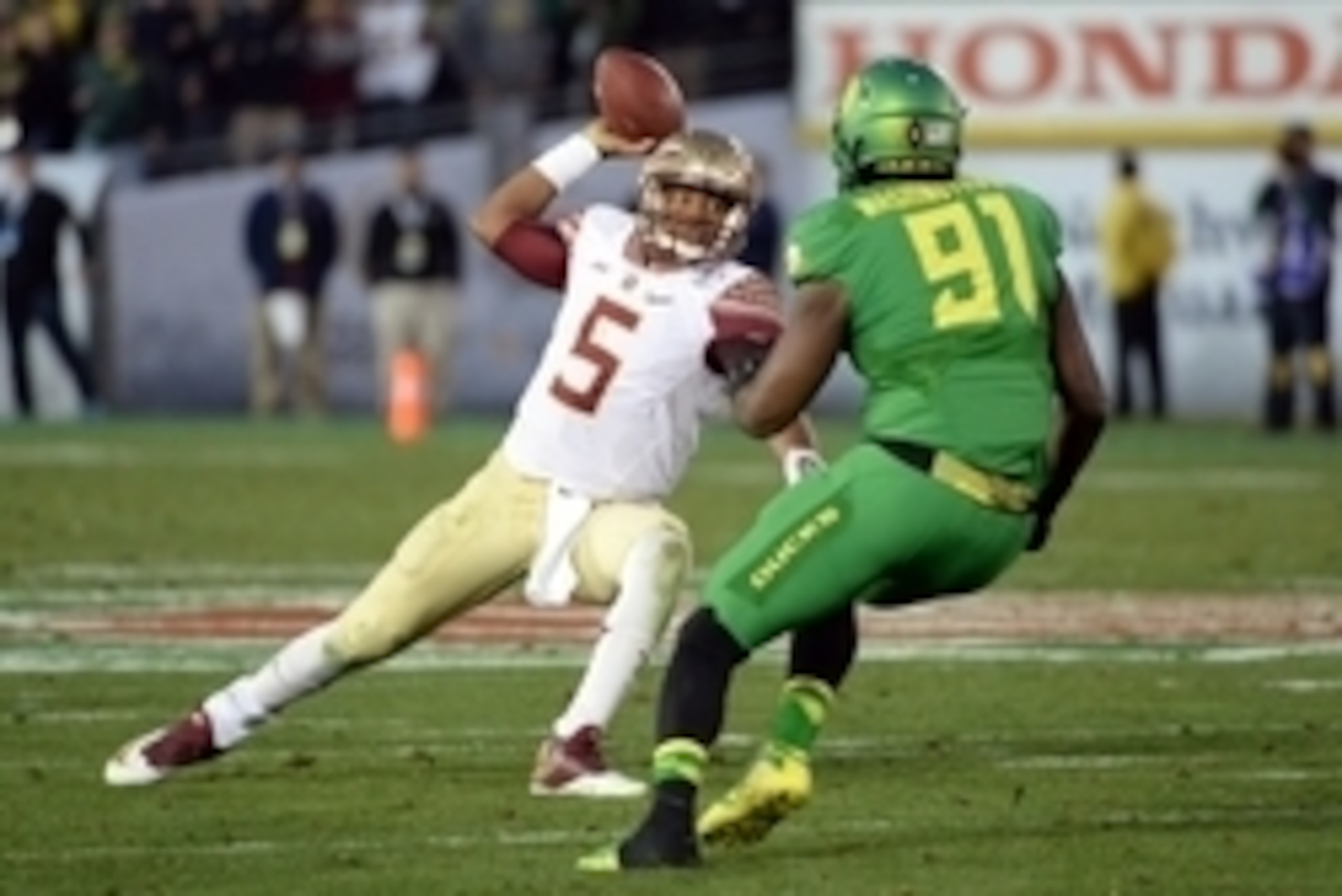 Jan 1, 2015; Pasadena, CA, USA; Florida State Seminoles quarterback Jameis Winston (5) scrambles under pressure from Oregon Ducks linebacker Tony Washington (91) in the 2015 Rose Bowl college football game at Rose Bowl. Mandatory Credit: Jayne Kamin-Oncea