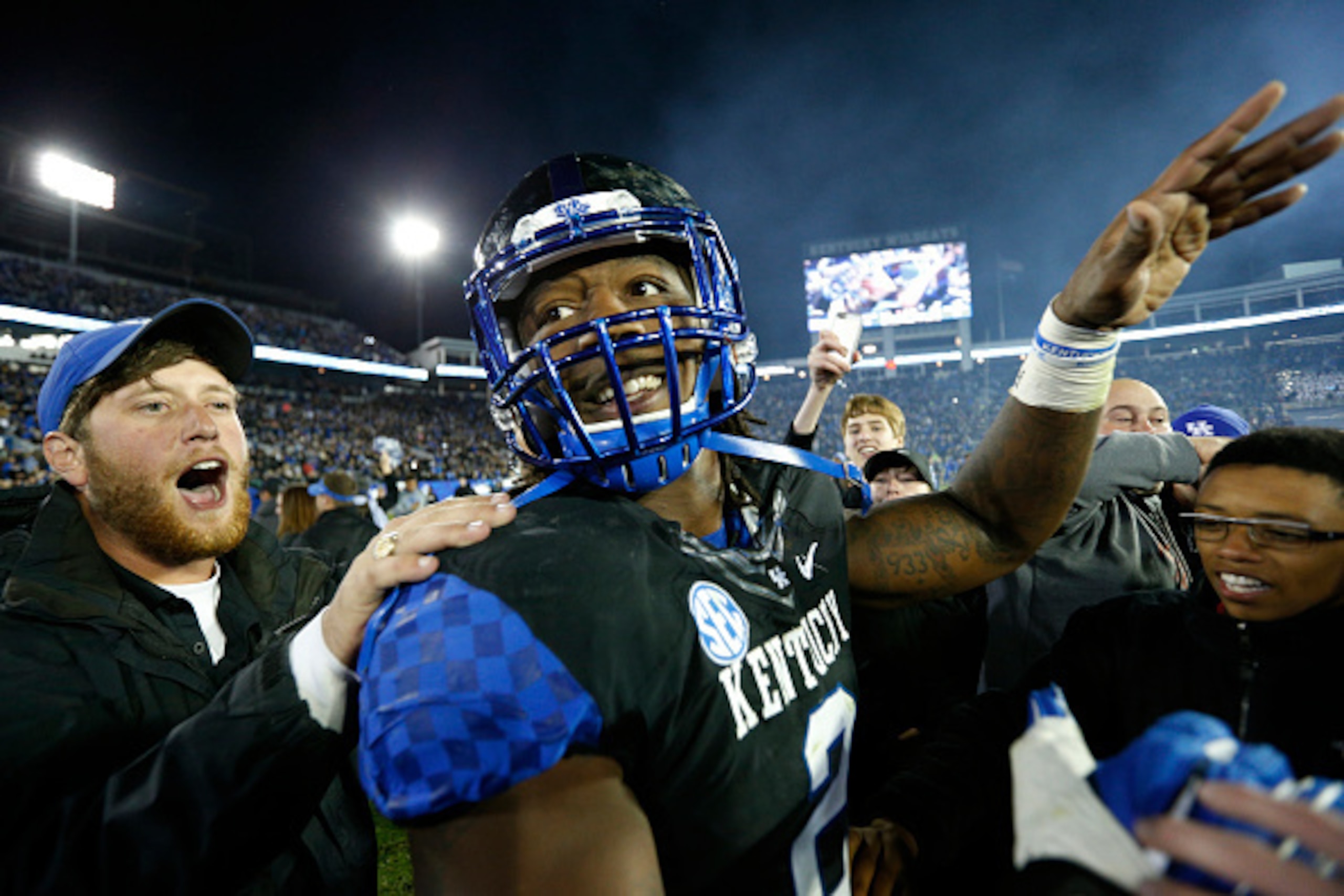 LEXINGTON, KY - OCTOBER 4: Alvin Dupree #2 of the Kentucky Wildcats celebrates with fans after the game against the South Carolina Gamecocks at Commonwealth Stadium on October 4, 2014 in Lexington, Kentucky. Kentucky defeated South Carolina 45-38 after Du