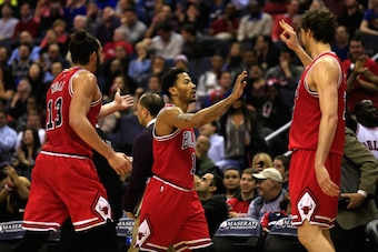 WASHINGTON, DC - DECEMBER 23: Derrick Rose #1 of the Chicago Bulls (C) celebrates after hitting a shot to end the first half with teammates Joakim Noah #13 and Pau Gasol #16 against the Washington Wizards at Verizon Center on December 23, 2014 in Washingt