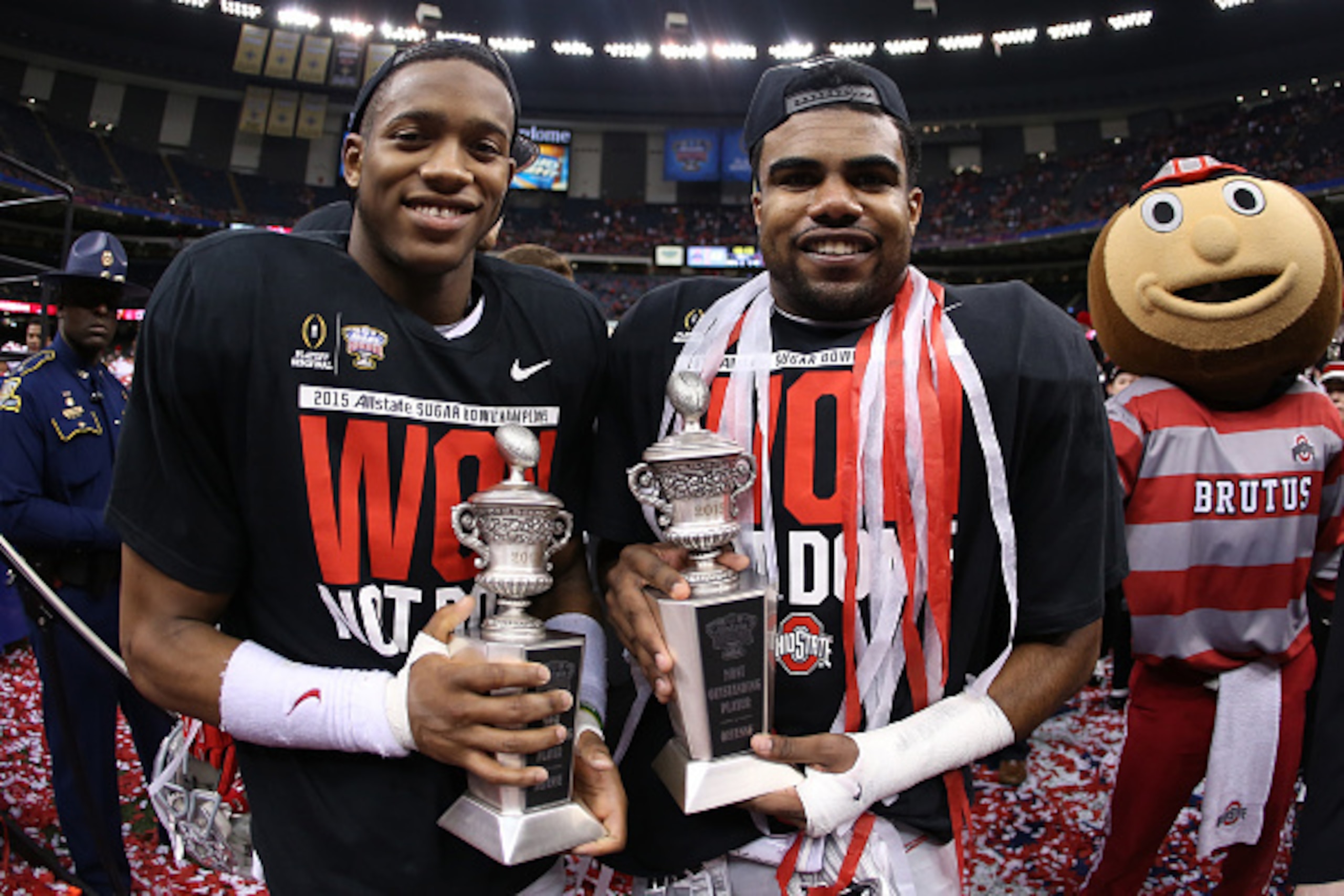 NEW ORLEANS, LA - JANUARY 01:  Darron Lee #43 and Ezekiel Elliott #15 of the Ohio State Buckeyes celebrates with the trophy after defeating the Alabama Crimson Tide in the All State Sugar Bowl at the Mercedes-Benz Superdome on January 1, 2015 in New Orlea