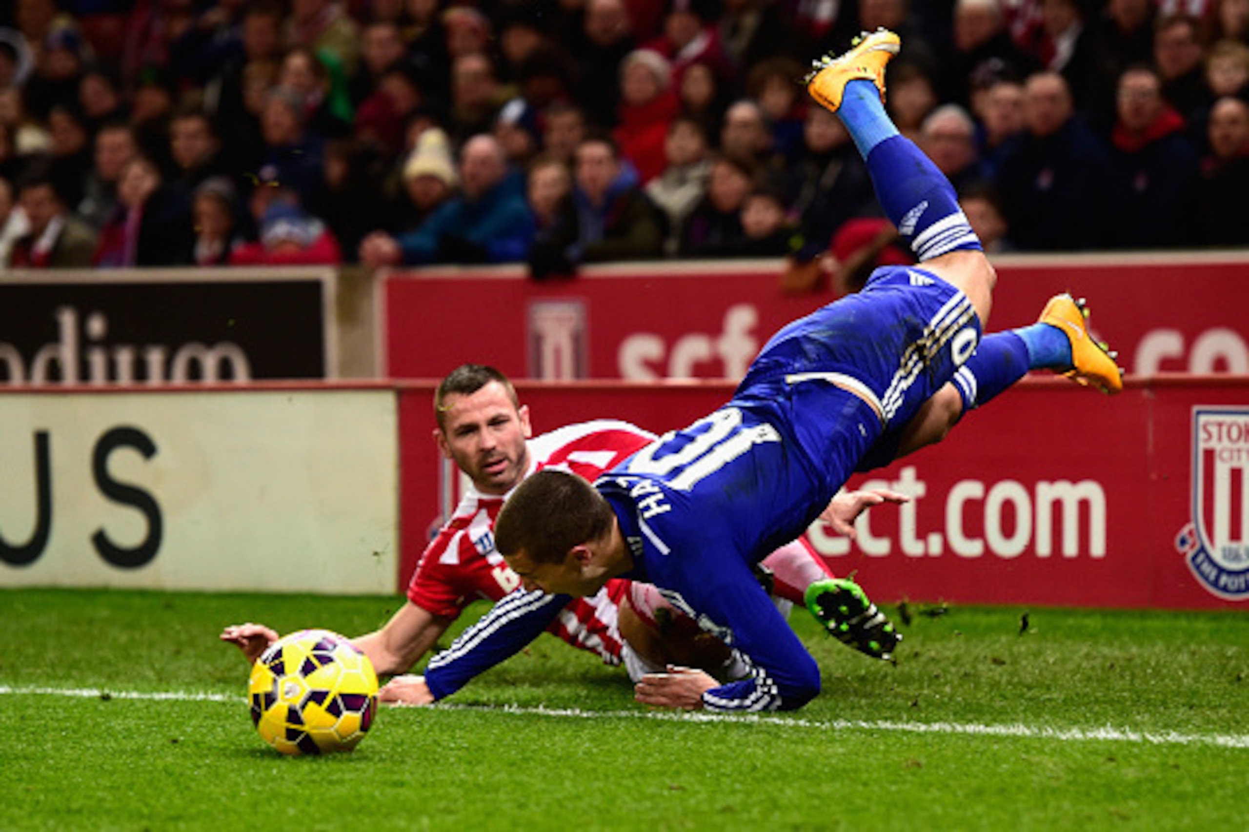 STOKE ON TRENT, ENGLAND - DECEMBER 22:  Chelsea player Eden Hazard is fouled by Phil Bardsley during the Barclays Premier League match between Stoke City and Chelsea at Britannia Stadium on December 22, 2014 in Stoke on Trent, England.  (Photo by Stu Fors