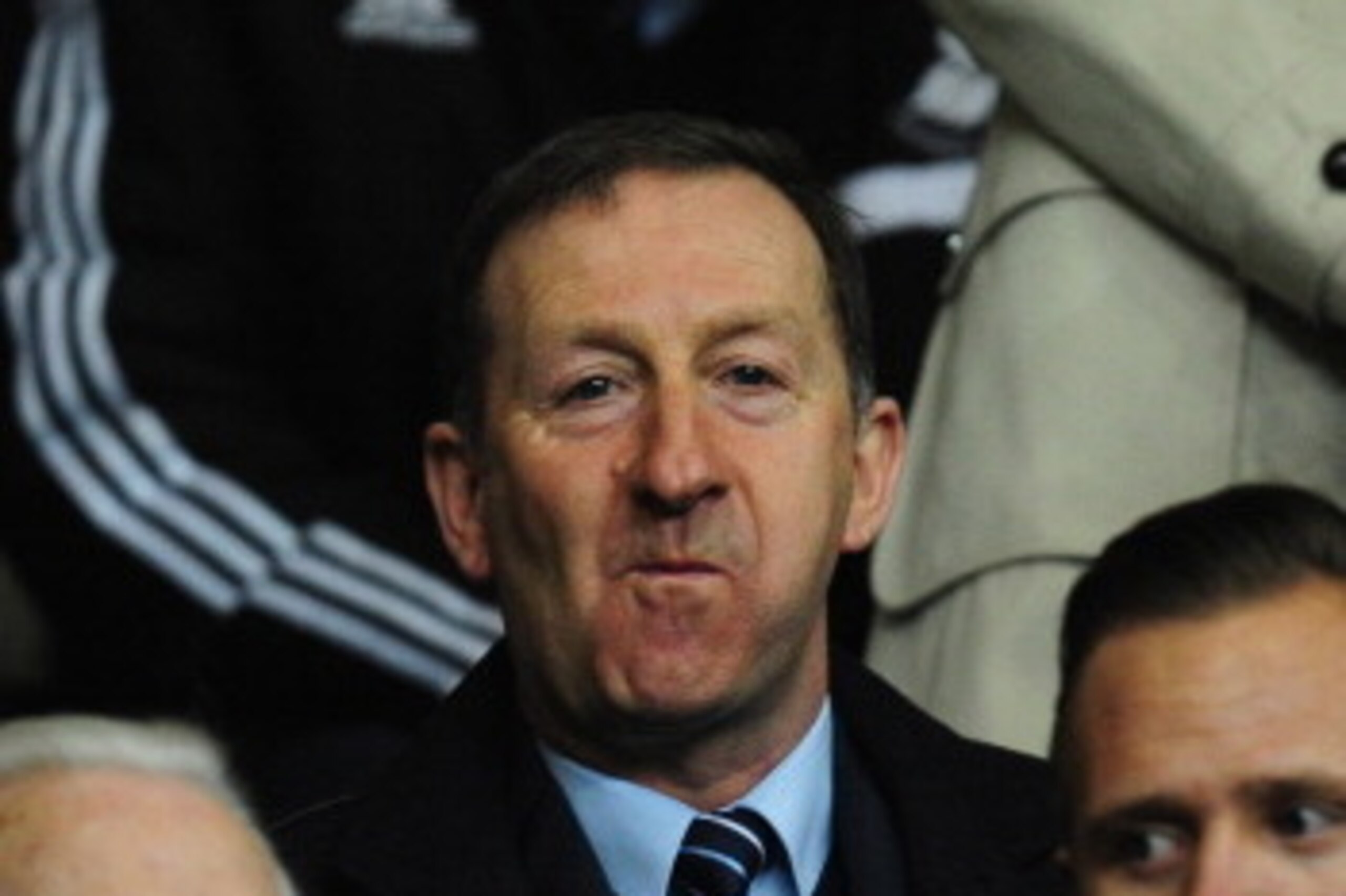 SWANSEA, WALES - FEBRUARY 20:  Swansea chairman Huw Jenkins (c) looks on before the UEFA Europa League Round of 32 first leg between Swansea City and SSC Napoli at Liberty Stadium on February 20, 2014 in Swansea, Wales.  (Photo by Stu Forster/Getty Images
