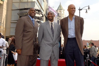 HOLLYWOOD - OCTOBER 30:  Earvin 'Magic' Johnson, Kobe Bryant and Kareem Abdul-Jabbar pose together at the ceremony for Dr. Jerry Buss, owner of the Los Angeles Lakers, as he is given a television star on the Hollywood Walk of Fame on October 30, 2006 in H