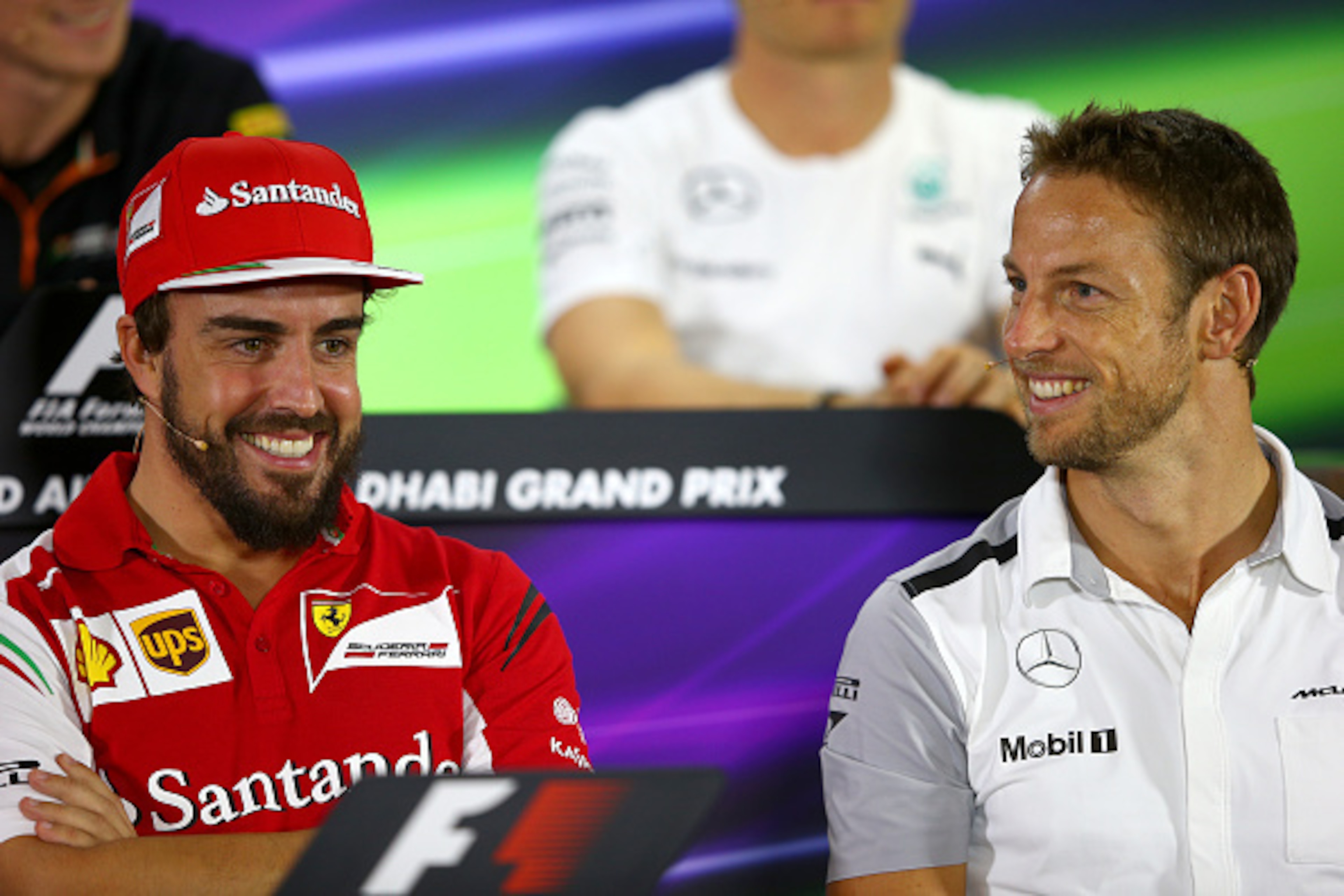 ABU DHABI, UNITED ARAB EMIRATES - NOVEMBER 20:  Fernando Alonso of Spain and Ferrari smiles with Jenson Button of Great Britain and McLaren during the drivers' press conference during previews ahead of the Abu Dhabi Formula One Grand Prix at Yas Marina Ci