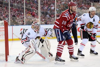 WASHINGTON, DC - JANUARY 01:  Troy Brouwer #20 of the Washington Capitals and Duncan Keith #2 of the Chicago Blackhawks stand in front of goalie Corey Crawford #50 during the 2015 Bridgestone NHL Winter Classic on January 1, 2015 in Washington, DC.  (Phot