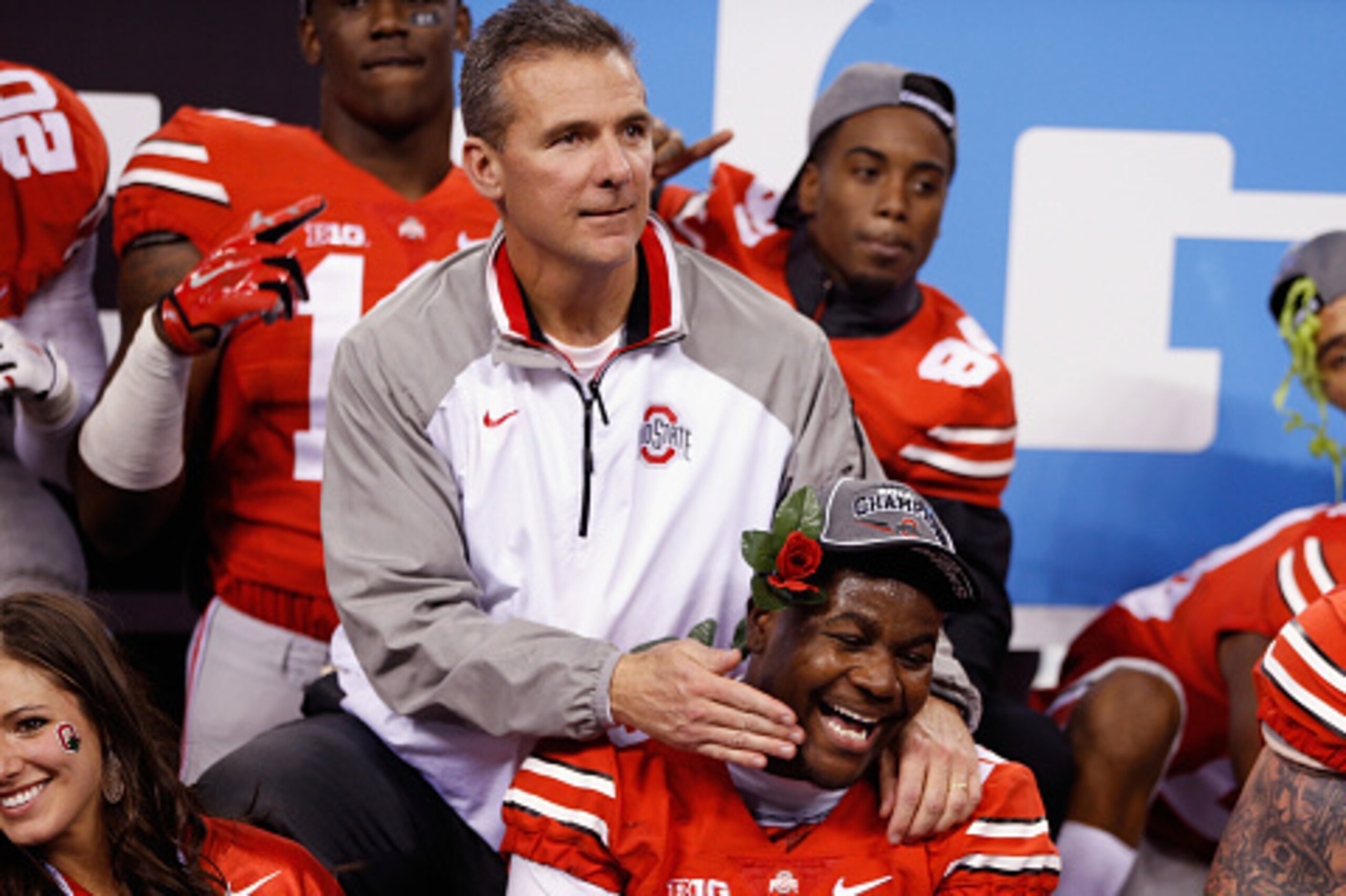INDIANAPOLIS, IN - DECEMBER 06:  Head coach Urban Meyer of the Ohio State Buckeyes celebrates with quarterback Cardale Jones #12 after their 59-0 win over the Wisconsin Badgers in the Big Ten Championship at Lucas Oil Stadium on December 6, 2014 in Indian