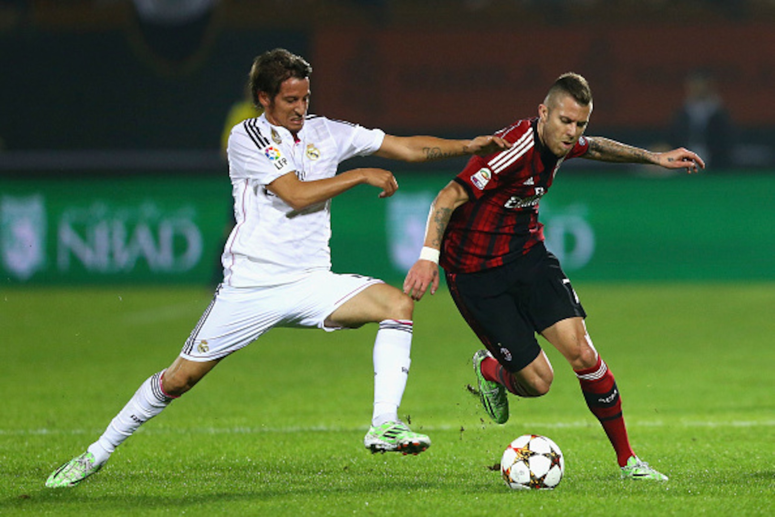 DUBAI, UNITED ARAB EMIRATES - DECEMBER 30:  Fabio Coentrao of Real Madrid battles for the ball with Jeremy Menez of AC Milan during the Dubai Football Challenge match between AC Milan and Real Madrid at The Sevens Stadium  on December 30, 2014 in Dubai, U