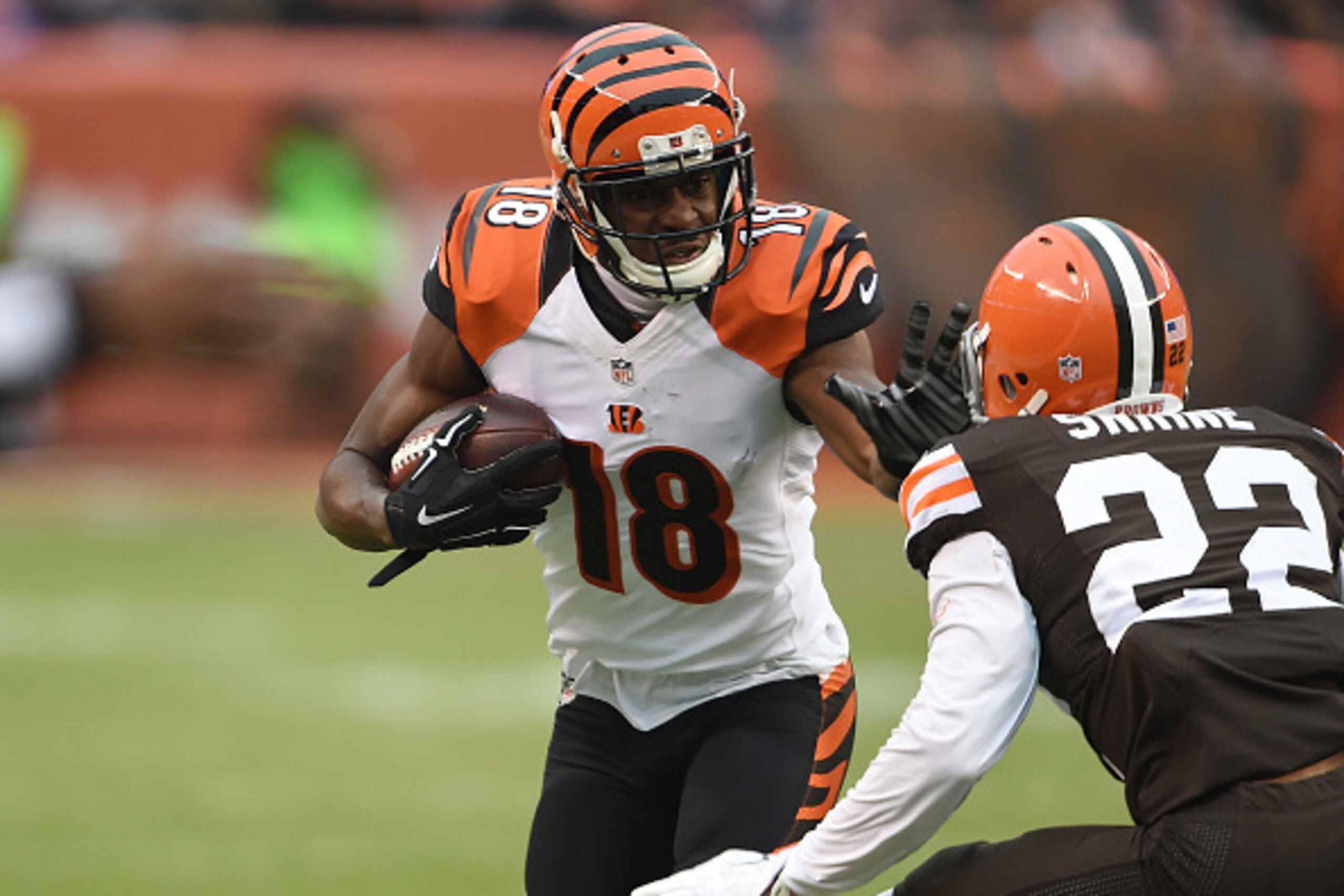 CLEVELAND, OH - DECEMBER 14:  A.J. Green #18 of the Cincinnati Bengals carries the ball in front of Buster Skrine #22 of the Cleveland Browns during the third quarter at FirstEnergy Stadium on December 14, 2014 in Cleveland, Ohio.  (Photo by Jason Miller/