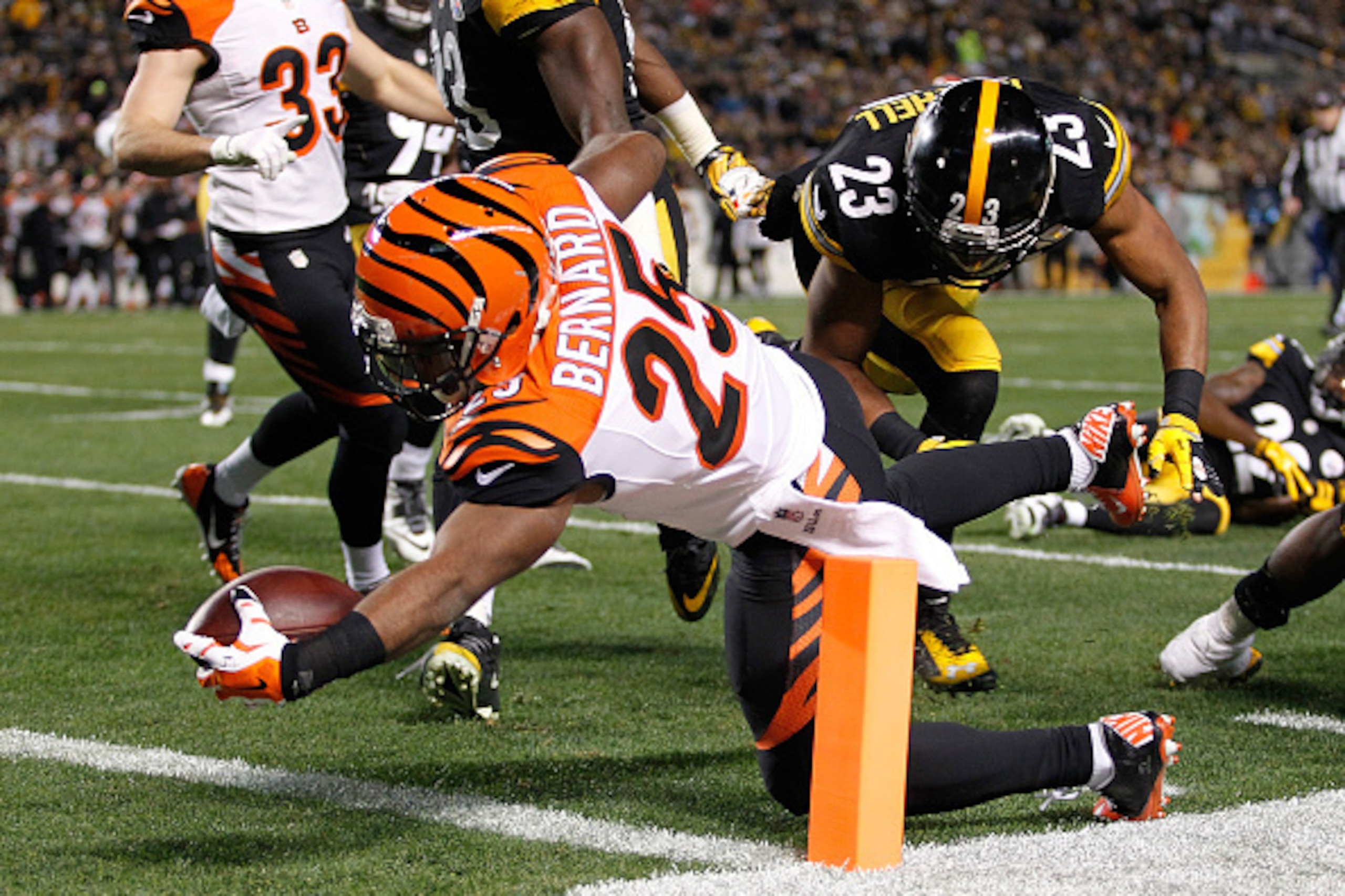 PITTSBURGH, PA - DECEMBER 28:  Giovani Bernard #25 of the Cincinnati Bengals dives in front of Mike Mitchell #23 of the Pittsburgh Steelers for a touchdown during the first quarter at Heinz Field on December 28, 2014 in Pittsburgh, Pennsylvania.  (Photo b