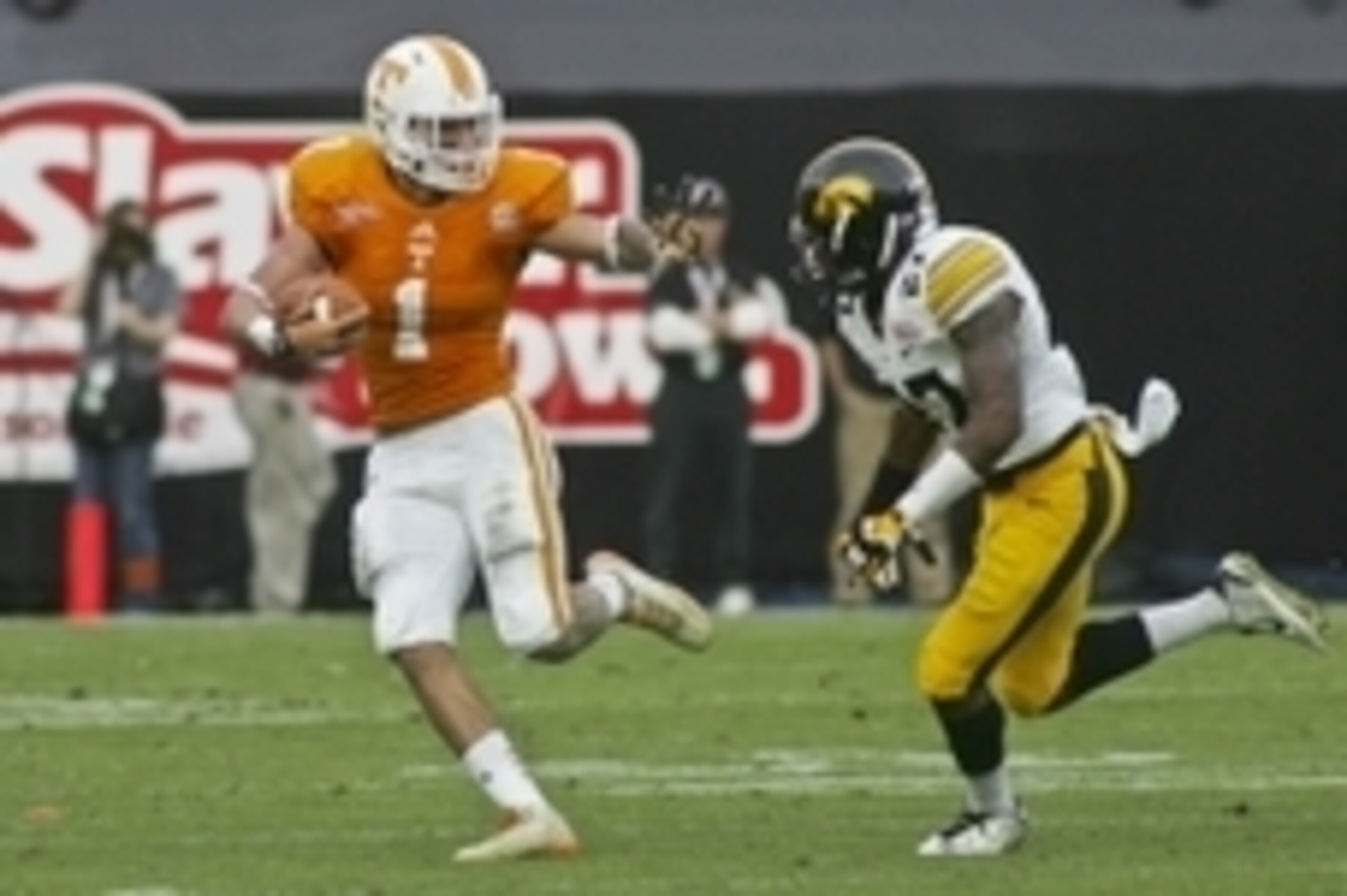 Jan 2, 2015; Jacksonville, FL, USA; Tennessee Volunteers running back Jalen Hurd (1) stiff arms Iowa Hawkeyes defensive back Jordan Lomax (27) in the first quarter of their 2015 TaxSlayer Bowl at EverBank Field. Mandatory Credit: Phil Sears-USA TODAY Spor