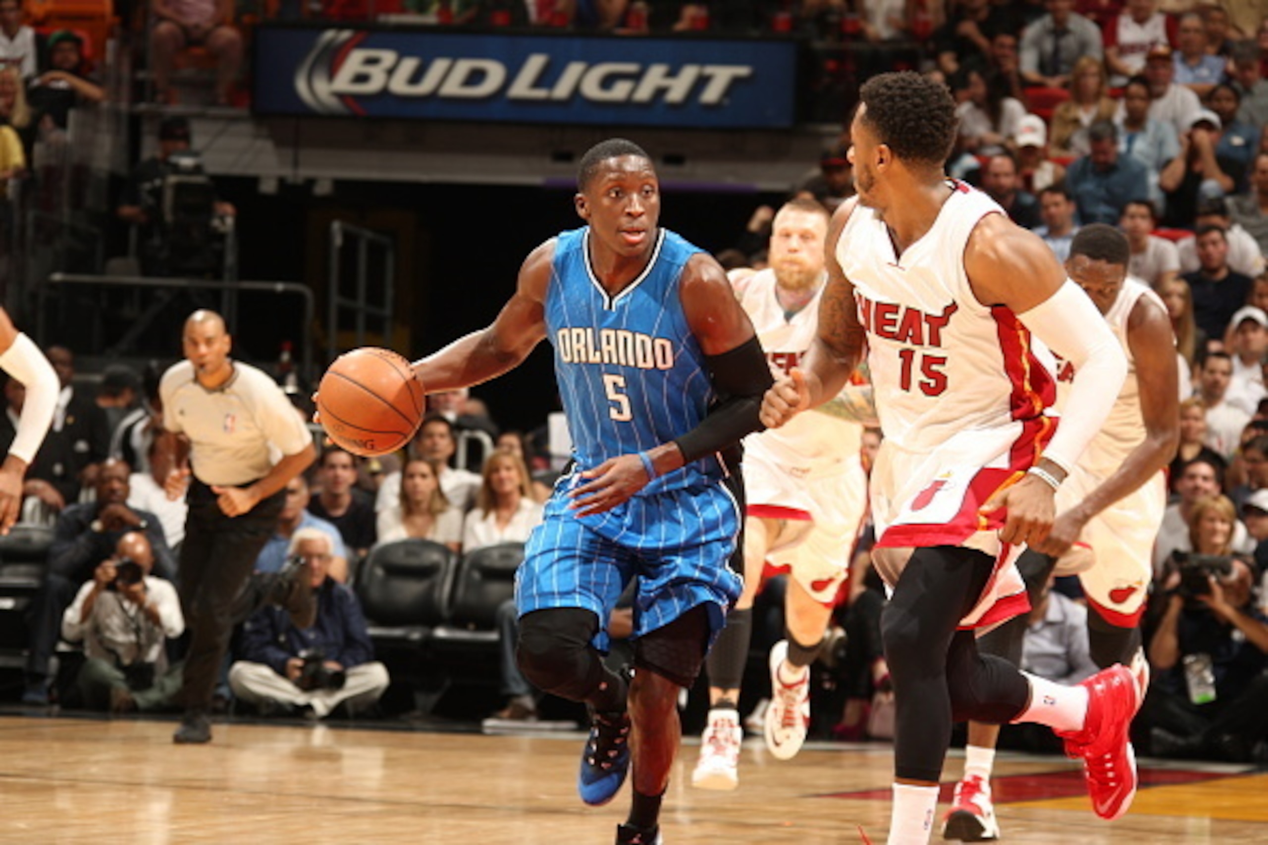 MIAMI, FL - DECEMBER 29:  Victor Oladipo #5 of the Orlando Magic brings the ball up court against Mario Chalmers #15 of the Miami Heat on December 29, 2014 at American Airlines Arena in Miami, Florida.  NOTE TO USER: User expressly acknowledges and agrees