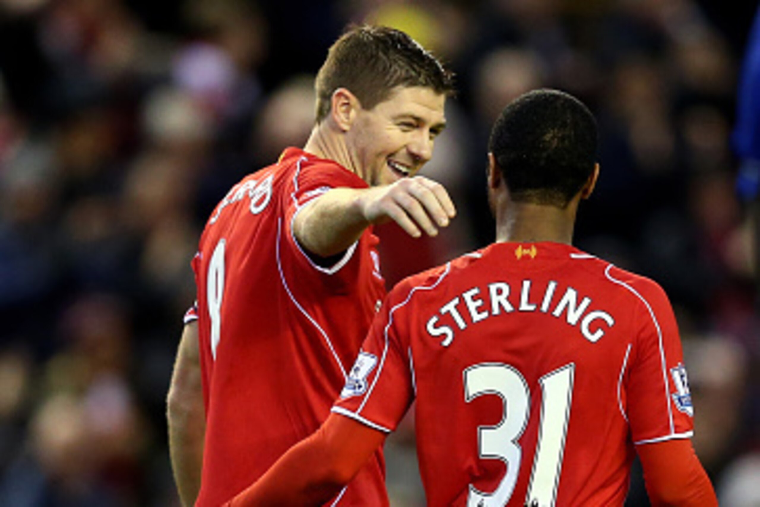 LIVERPOOL, ENGLAND - JANUARY 01:  Steven Gerrard of Liverpool celebrateswith teammate Raheem Sterling of Liverpool after scoring his team's second goal from the penalty spot during the Barclays Premier League match between Liverpool and Leicester City at 