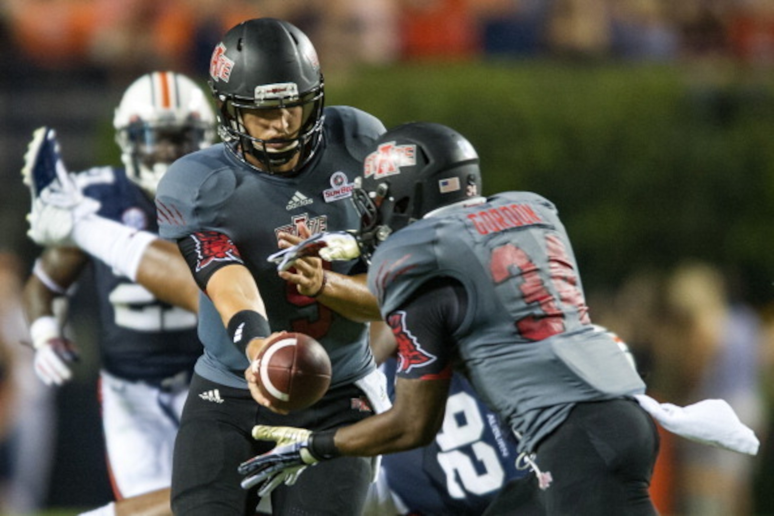 AUBURN, AL - SEPTEMBER 7:  Quarterback Adam Kennedy #5 of the Arkansas State Red Wolves hands the ball off to running back Michael Gordon #34 of the Arkansas State Red Wolves during the first half of play on September 7, 2013 at Jordan-Hare Stadium in Aub