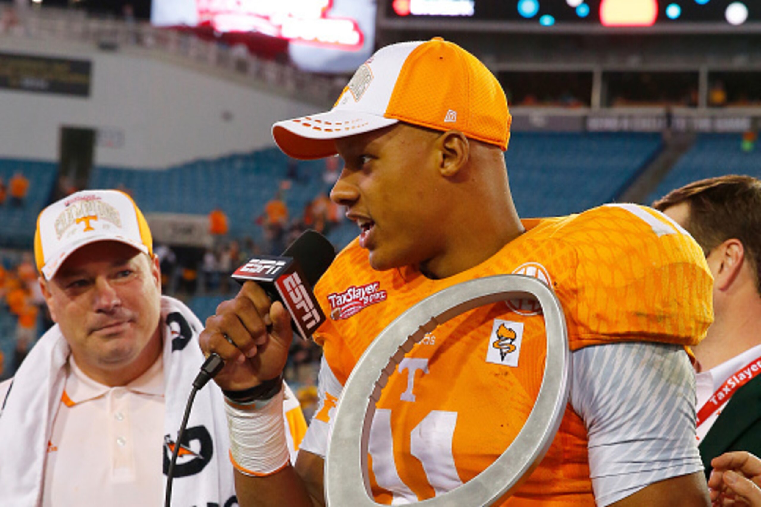 JACKSONVILLE, FL - JANUARY 02:  Joshua Dobbs #11 of the Tennessee Volunteers receives the MVP trophy following the TaxSlayer Bowl against the Iowa Hawkeyes at EverBank Field on January 2, 2015 in Jacksonville, Florida.  The Tennessee Volunteers defeated t