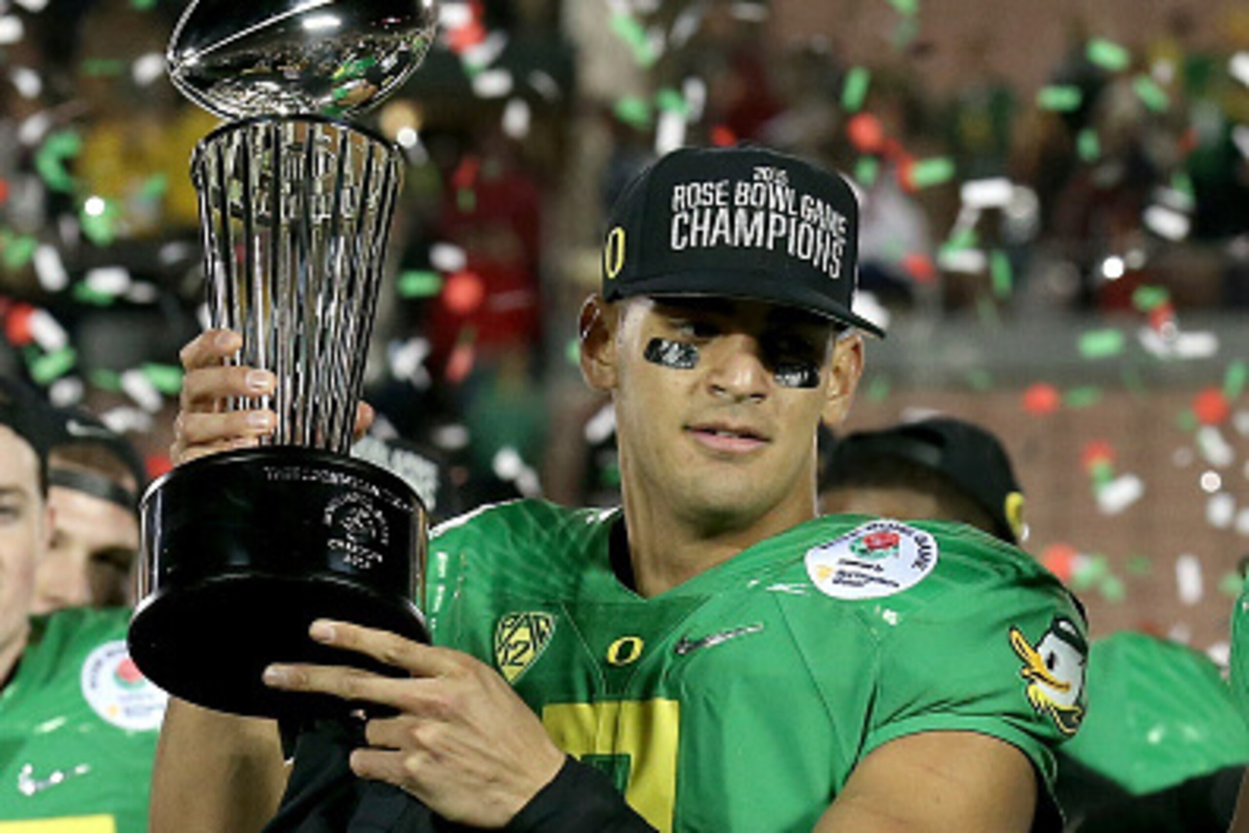 PASADENA, CA - JANUARY 01:  Quarterback Marcus Mariota #8 of the Oregon Ducks celebrates with the Leishman Trophy after defeating the Florida State Seminoles 59-20 in the College Football Playoff Semifinal at the Rose Bowl Game presented by Northwestern M