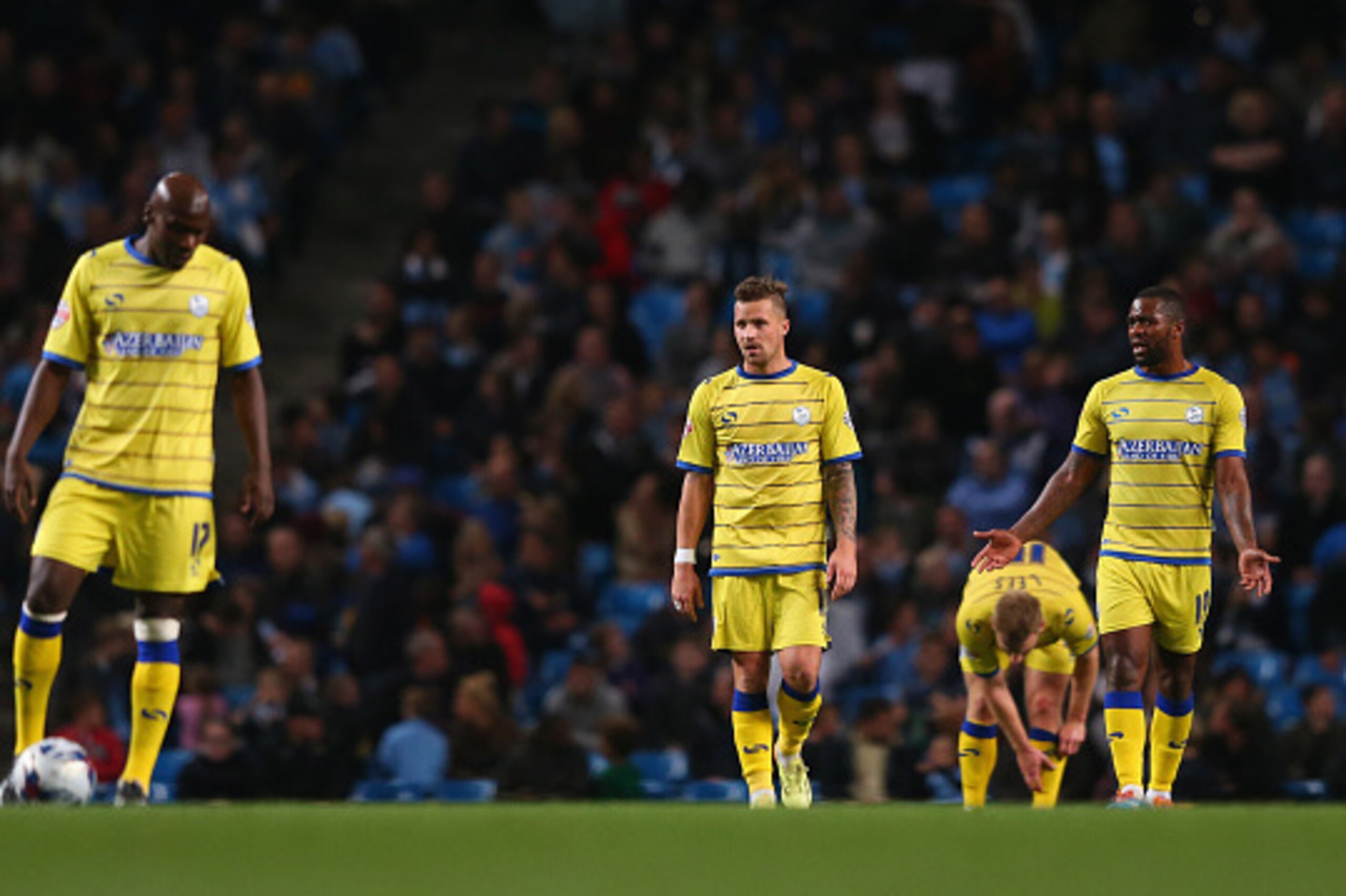 MANCHESTER, ENGLAND - SEPTEMBER 24:  The players of Sheffield Wednesday look dejected after conceding a goal during the Capital One Cup Third Round match between Manchester City and Sheffield Wednesday at Etihad Stadium on September 24, 2014 in Manchester
