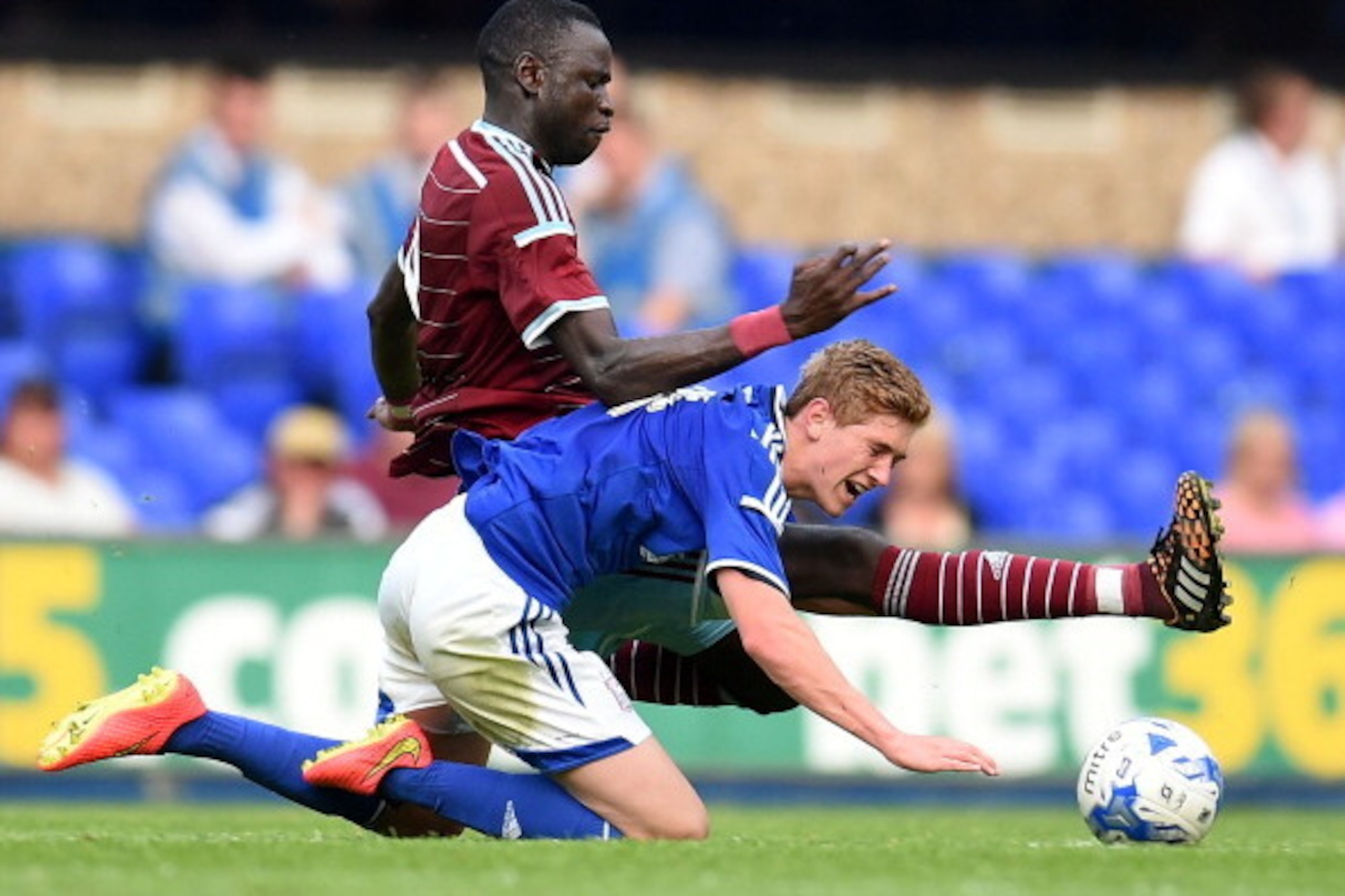 IPSWICH, ENGLAND - JULY 16: Cheikhou Kouyate of West Ham United and Teddy Bishop of Ipswich Town in action during the pre-season friendly match between Ipswich Town and West Ham United at Portman Road on July 16, 2014 in Ipswich, England. (Photo by Tom Du