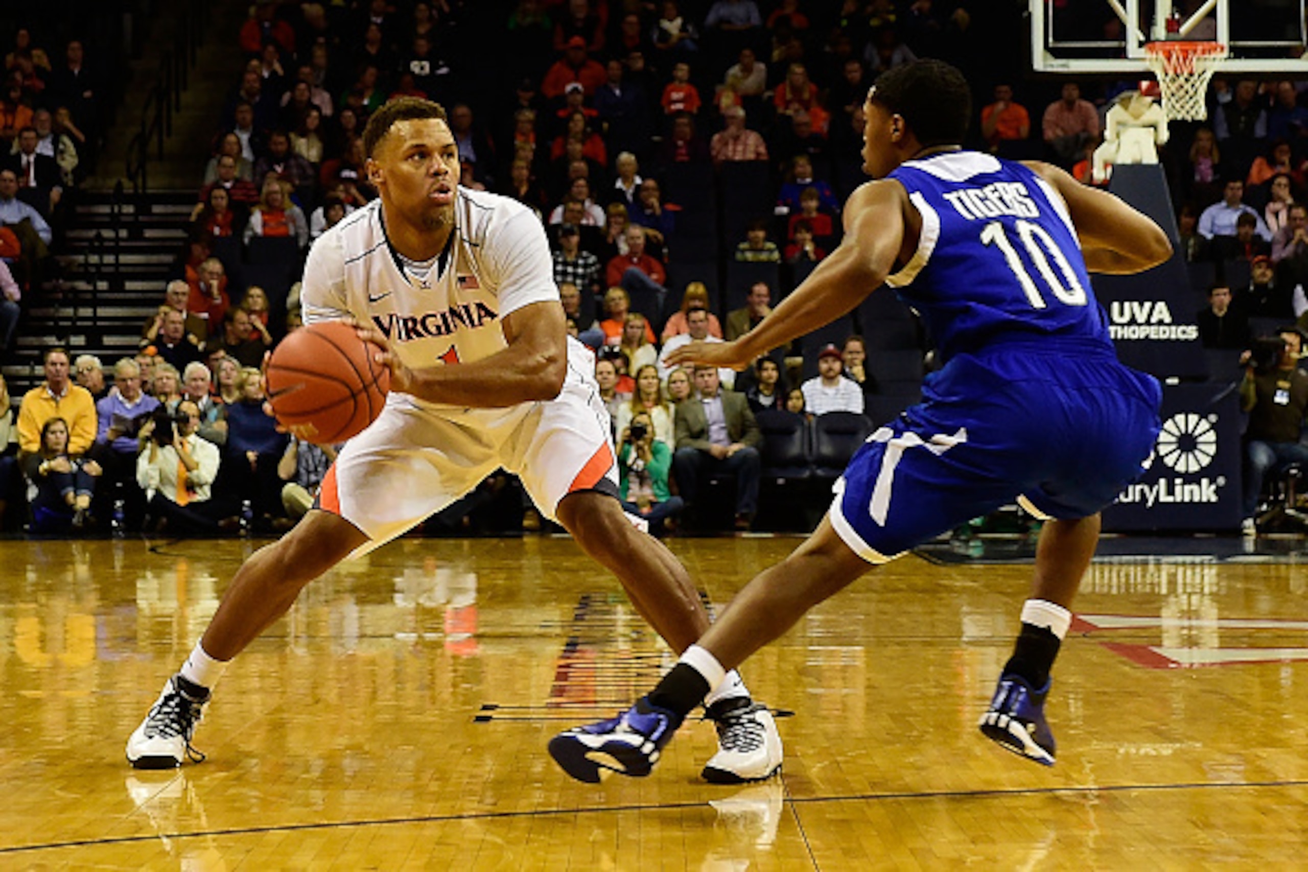 CHARLOTTESVILLE, VA - NOVEMBER 25: Justin Anderson #1 of the Virginia Cavaliers controls the ball against Charles Tucker #10 of the Tennessee State Tigers in the first half during a game at John Paul Jones Arena on November 25, 2014 in Charlottesville, Vi
