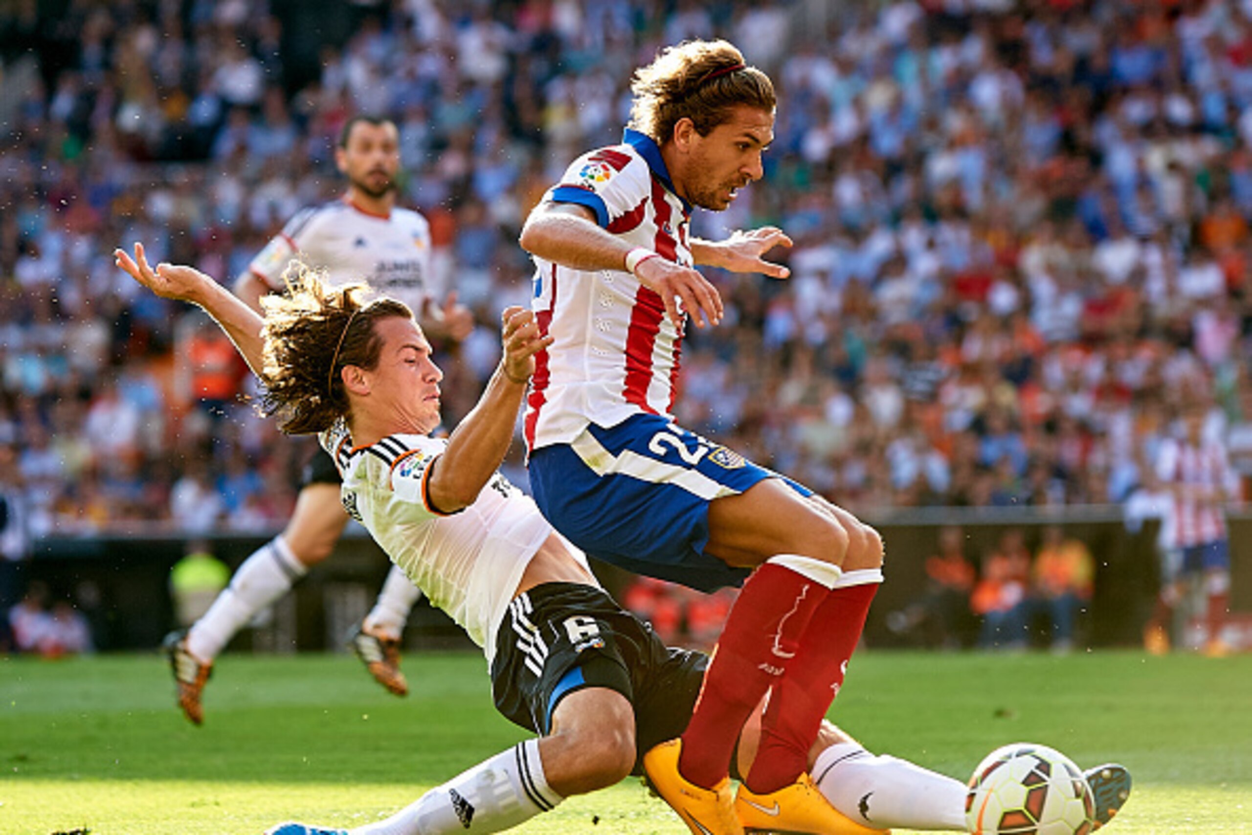 VALENCIA, SPAIN - OCTOBER 04:  Alessio Cerci (R) of Atletico de Madrid is tackled by Lucas Orban of Valencia during the La Liga match between Valencia CF and Club Atletico de Madrid at Estadi de Mestalla on October 4, 2014 in Valencia, Spain.  (Photo by M