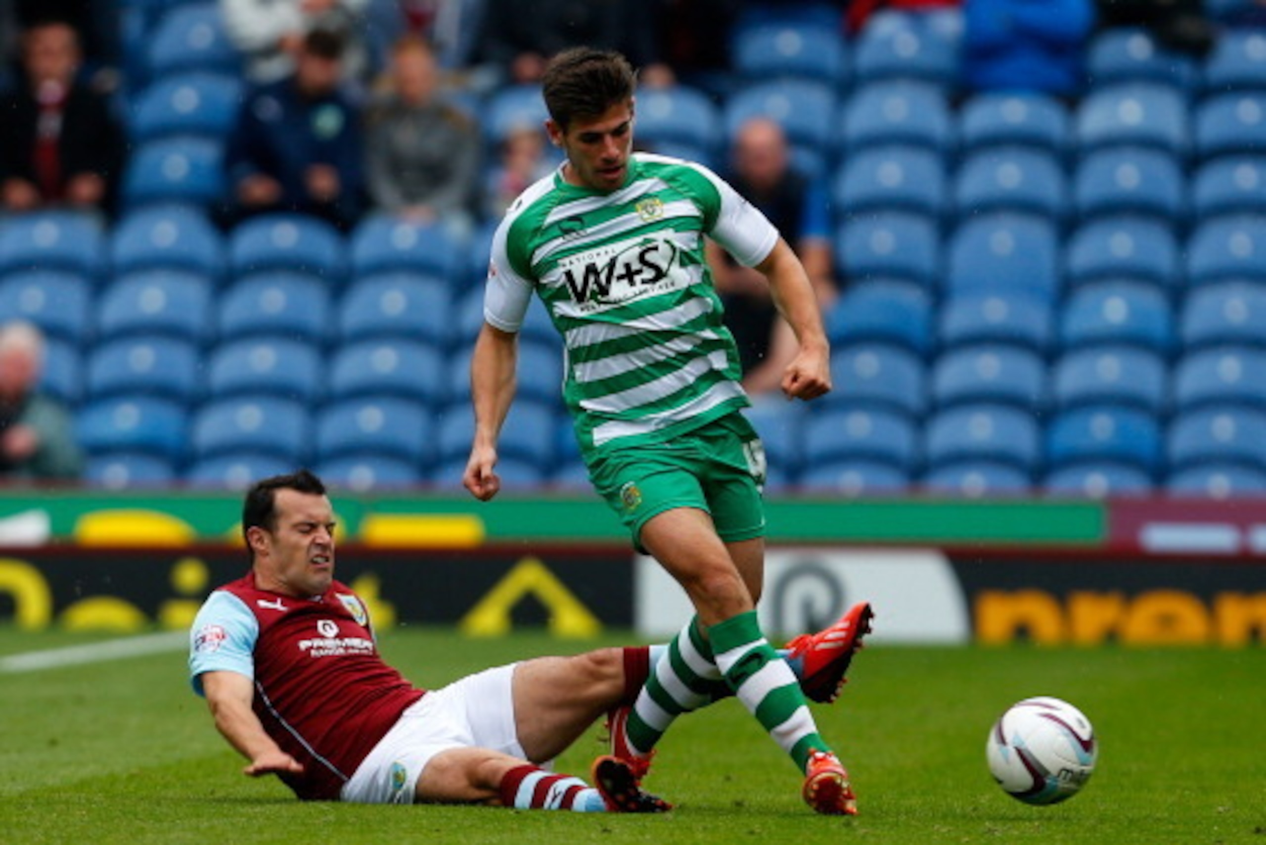 BURNLEY, ENGLAND - AUGUST 17: Ross Wallace of Burnley in action with Joe Edwards (R) of Yeovil during the Sky Bet Championship match between Burnley and Yeovil Town at Turf Moor on August 17, 2013 in Burnley, England (Photo by Paul Thomas/Getty Images)