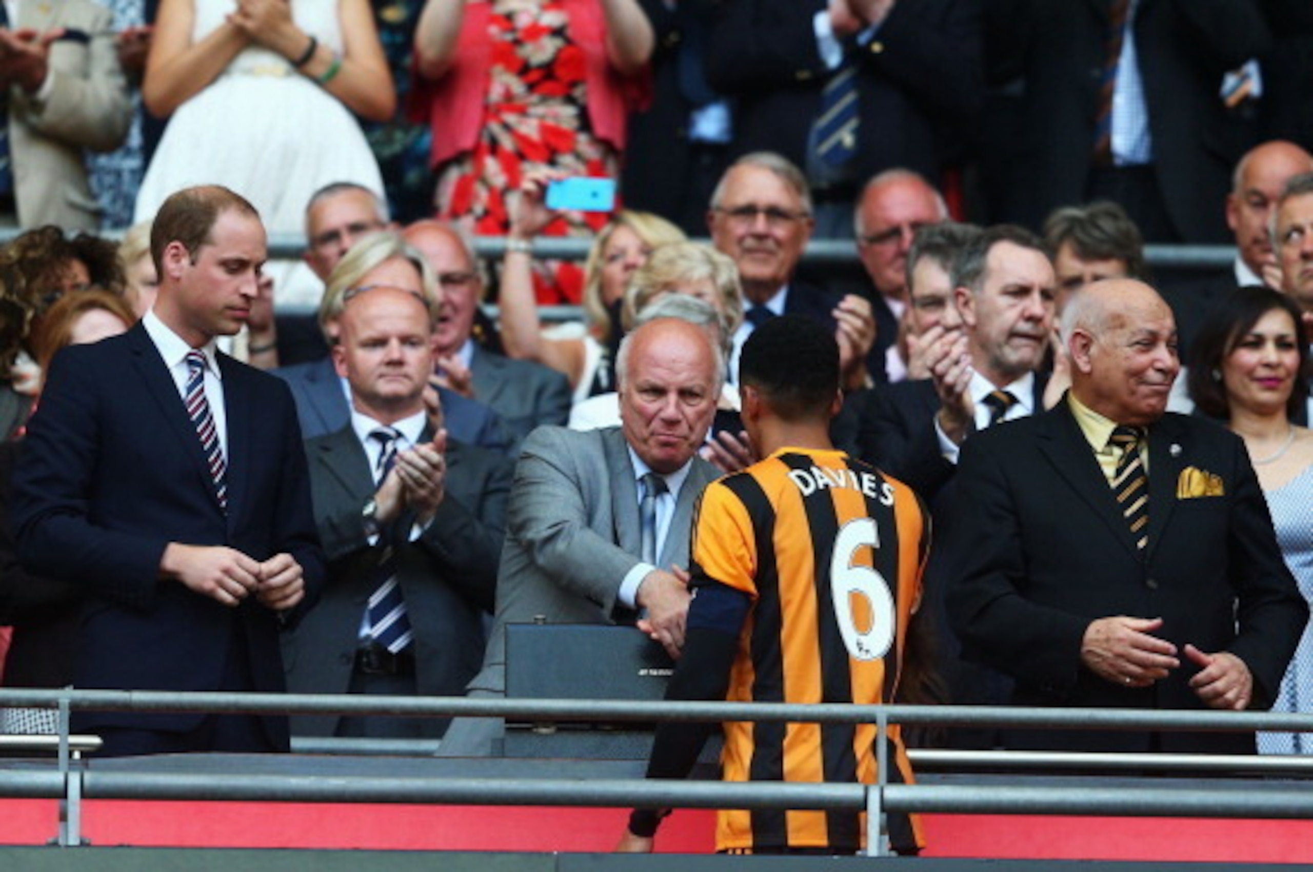 LONDON, ENGLAND - MAY 17:  Losing captain Curtis Davies of Hull City shakes hands with FA chairman Greg Dyke as Prince William, Duke of Cambridge and Hull City chairman Assem Allam look on after the FA Cup with Budweiser Final match between Arsenal and Hu